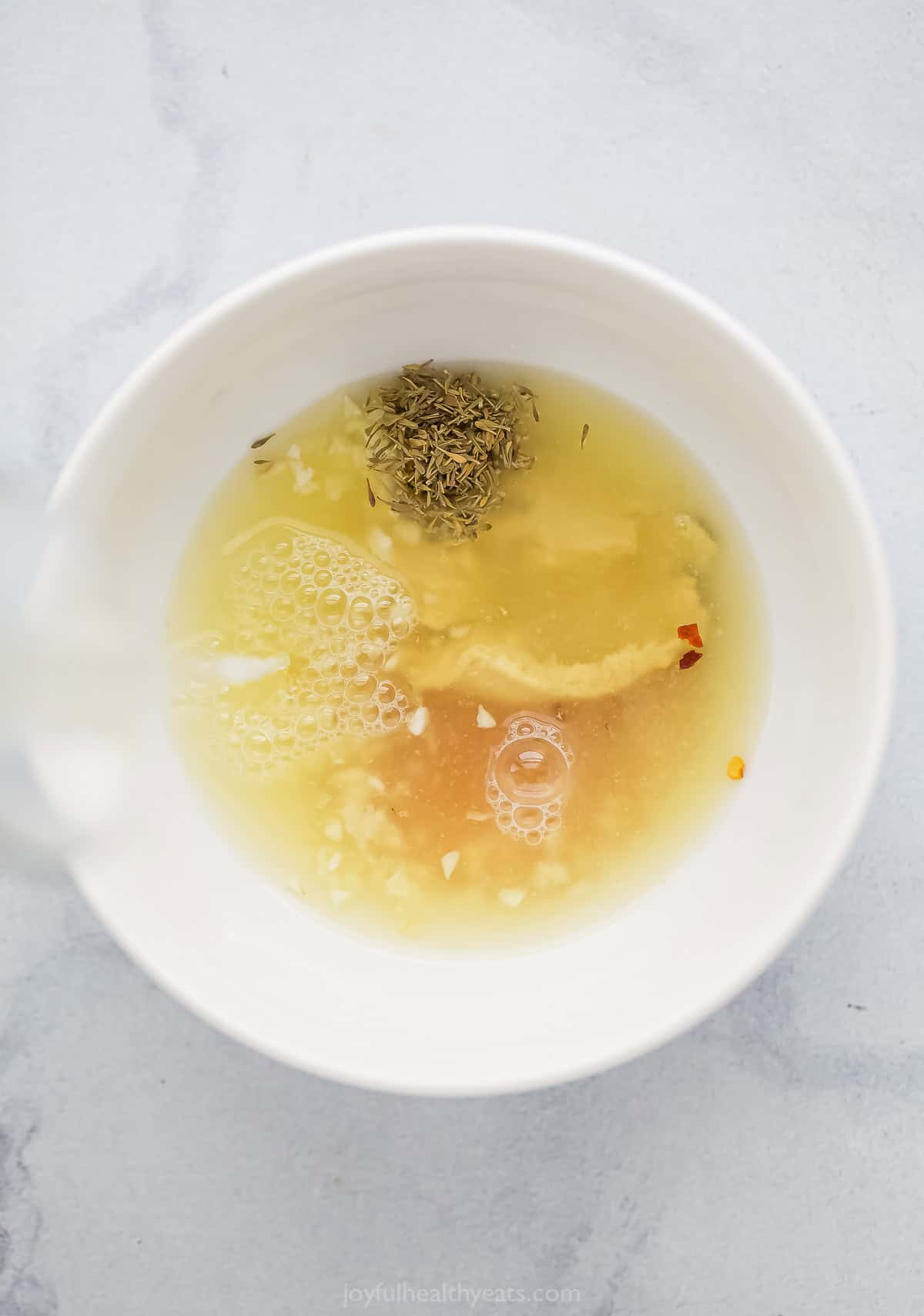 Adding the lemon juice to the dressing ingredients. 