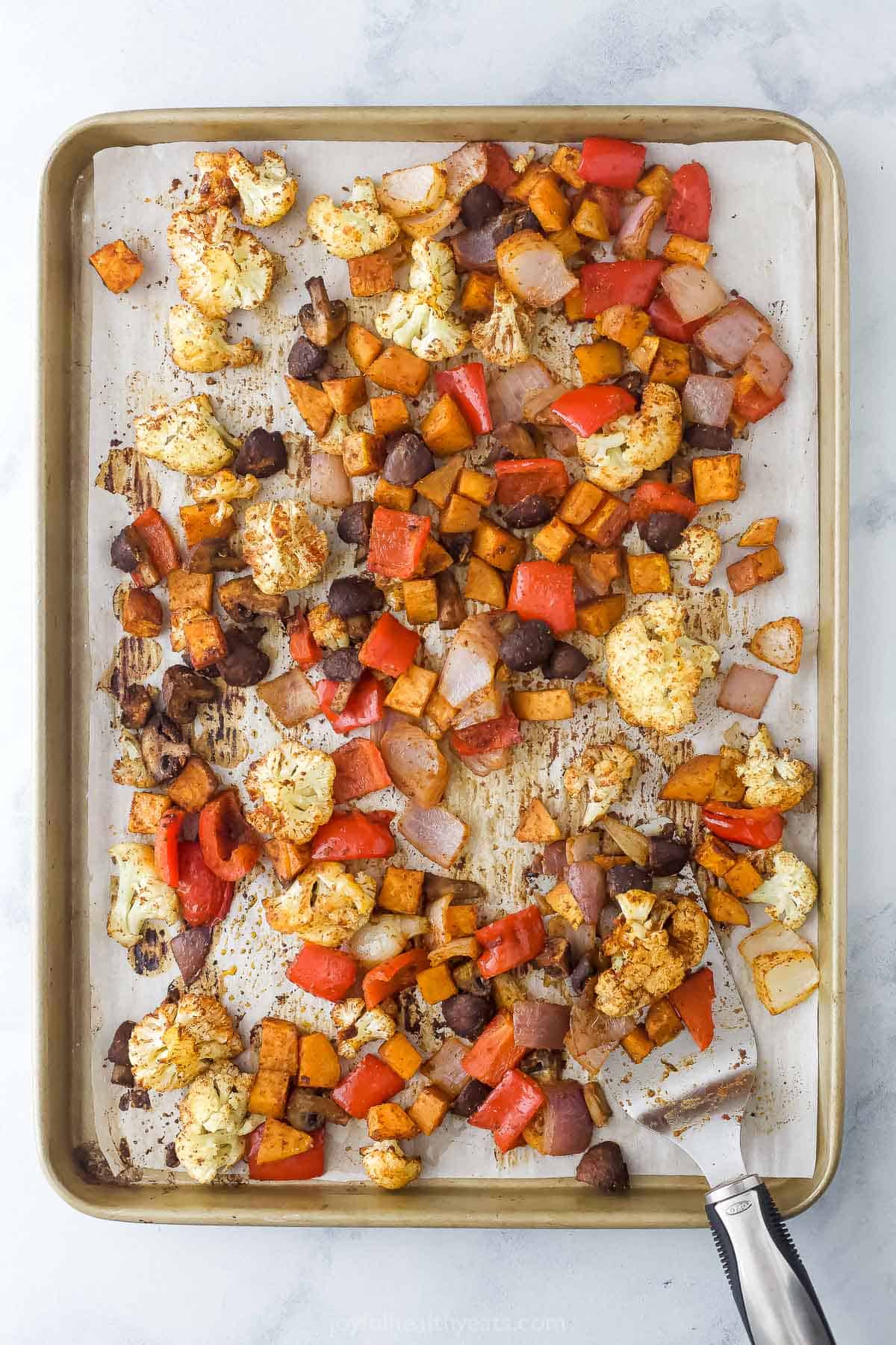 Roasted veggies on the baking sheet. 
