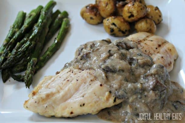 Grilled Chicken with Mushroom Thyme Cream Sauce A Plate of Chicken with Creamy Mushroom Sauce and Veggies on the Side
