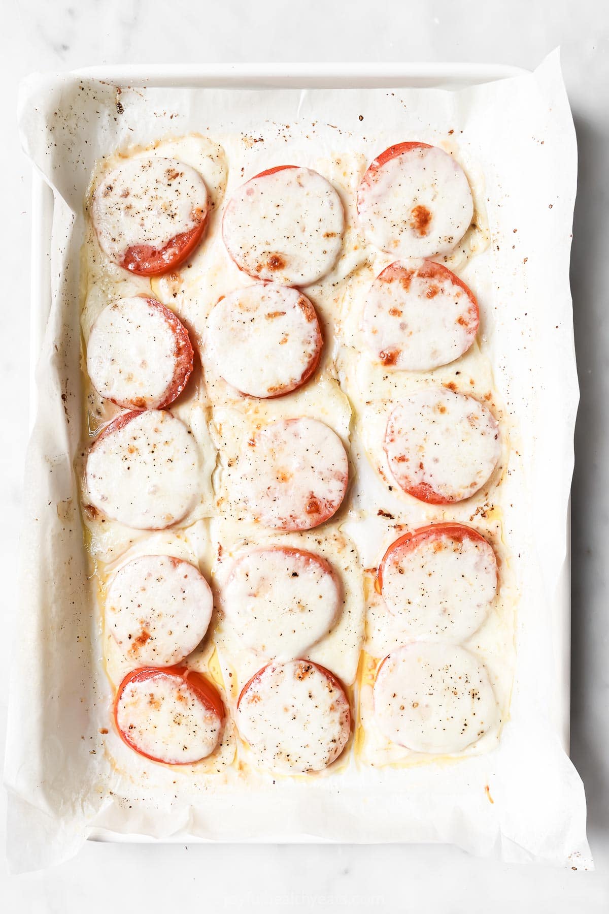 Broiled tomatoes with melty cheese. 