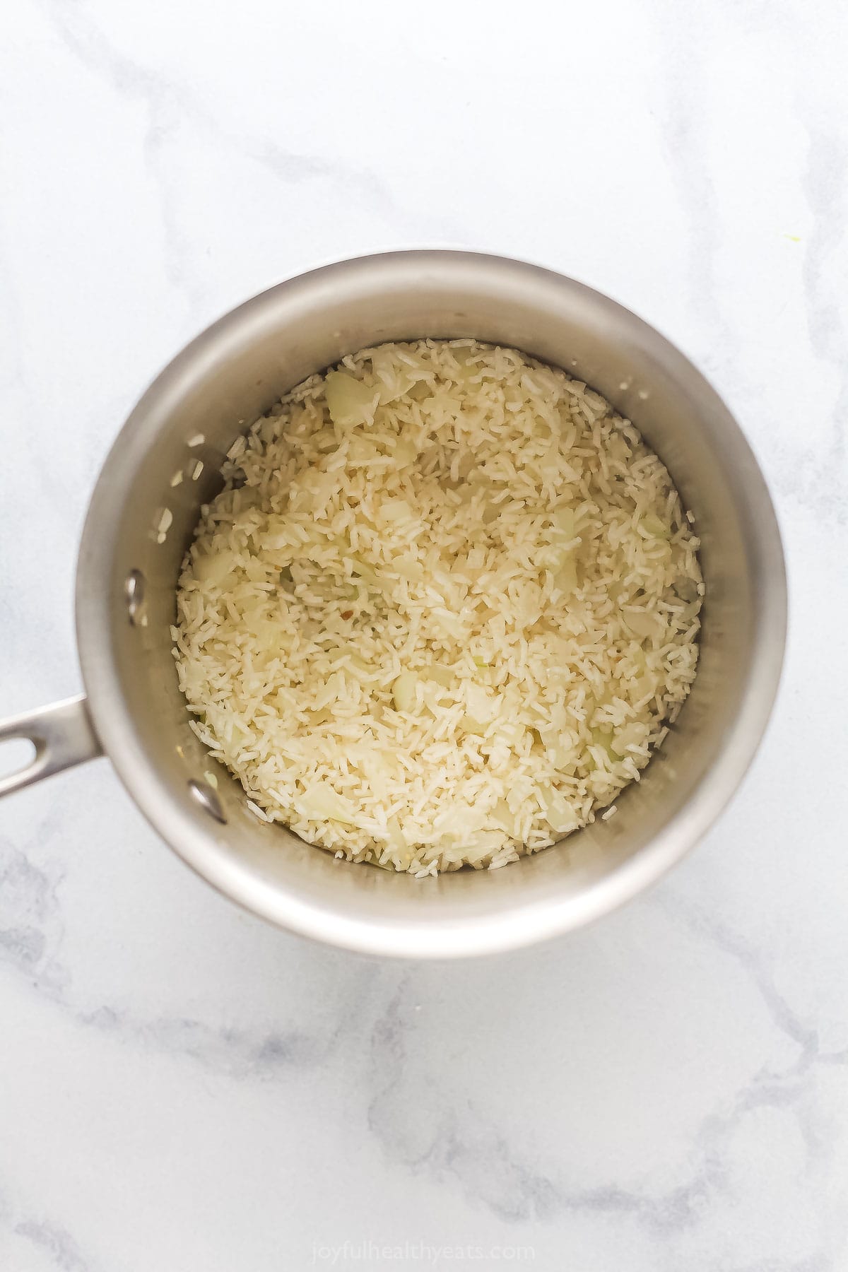 Stirring the rice into the pot. 