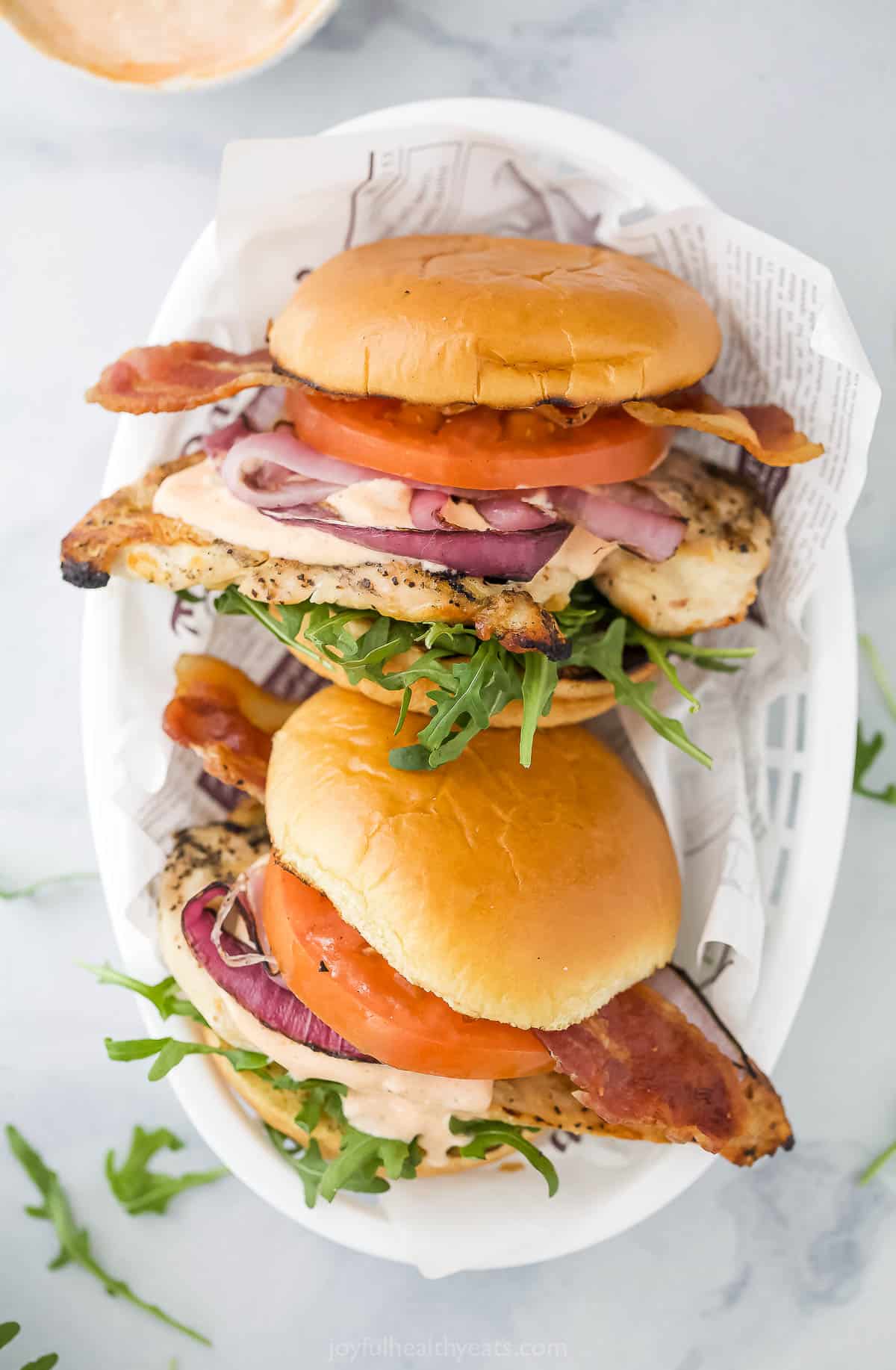 This crispy grilled chicken sandwich recipe with creamy chipotle mayo, savory cheese, and fresh veggies is a quick lunch. Two grilled chicken sandwiches with chipotle mayo, tomatoes, and spring mix salad.