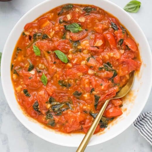 Overhead view of homemade pasta sauce in bowl with spoon