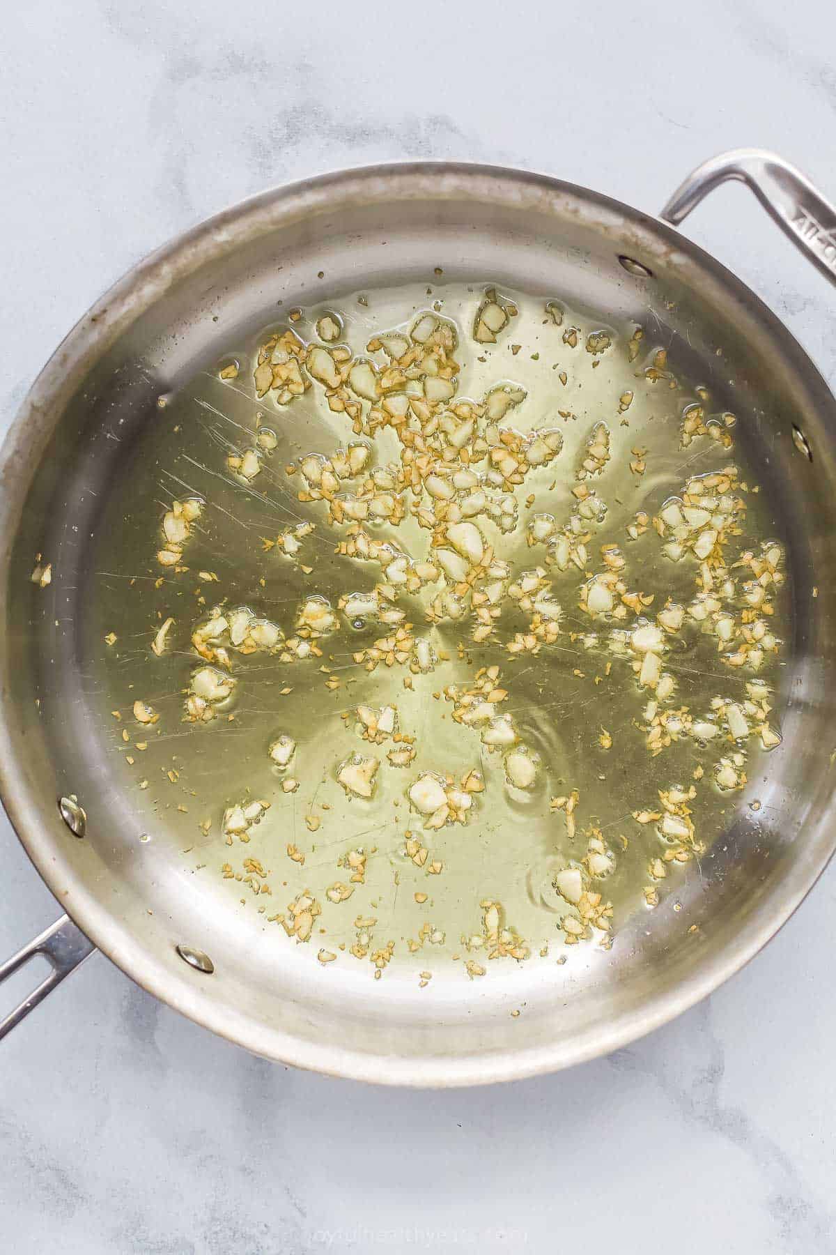 Garlic cooking in oil in skillet