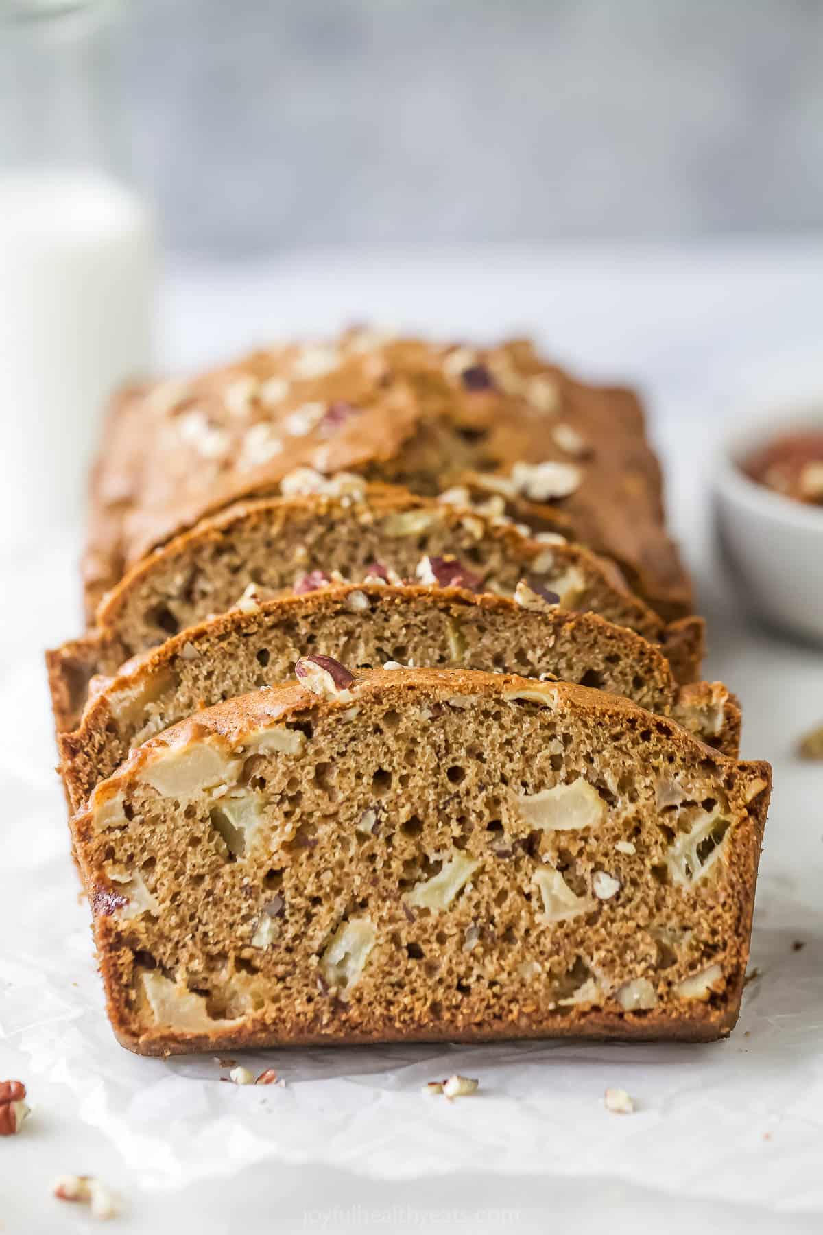This cinnamon-spiced apple bread recipe with crunchy pecans is a freezer-friendly dessert that's perfect for fall. Fluffy, sliced apple bread recipe with crunchy pecans.