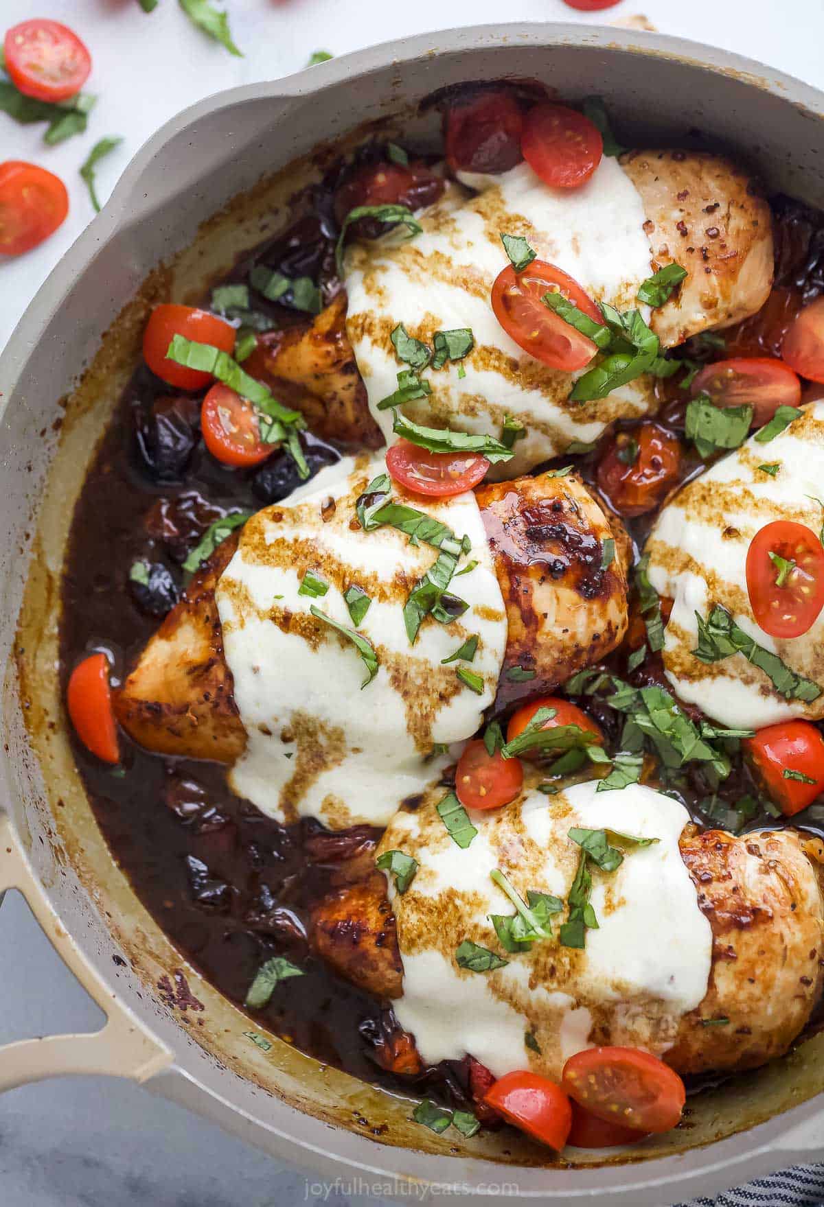 This chicken caprese recipe with basil, mozzarella, and cherry tomatoes is an easy dinner with Italian vibes and a balsamic reduction. Juicy chicken caprese with melty mozzarella and fresh basil.