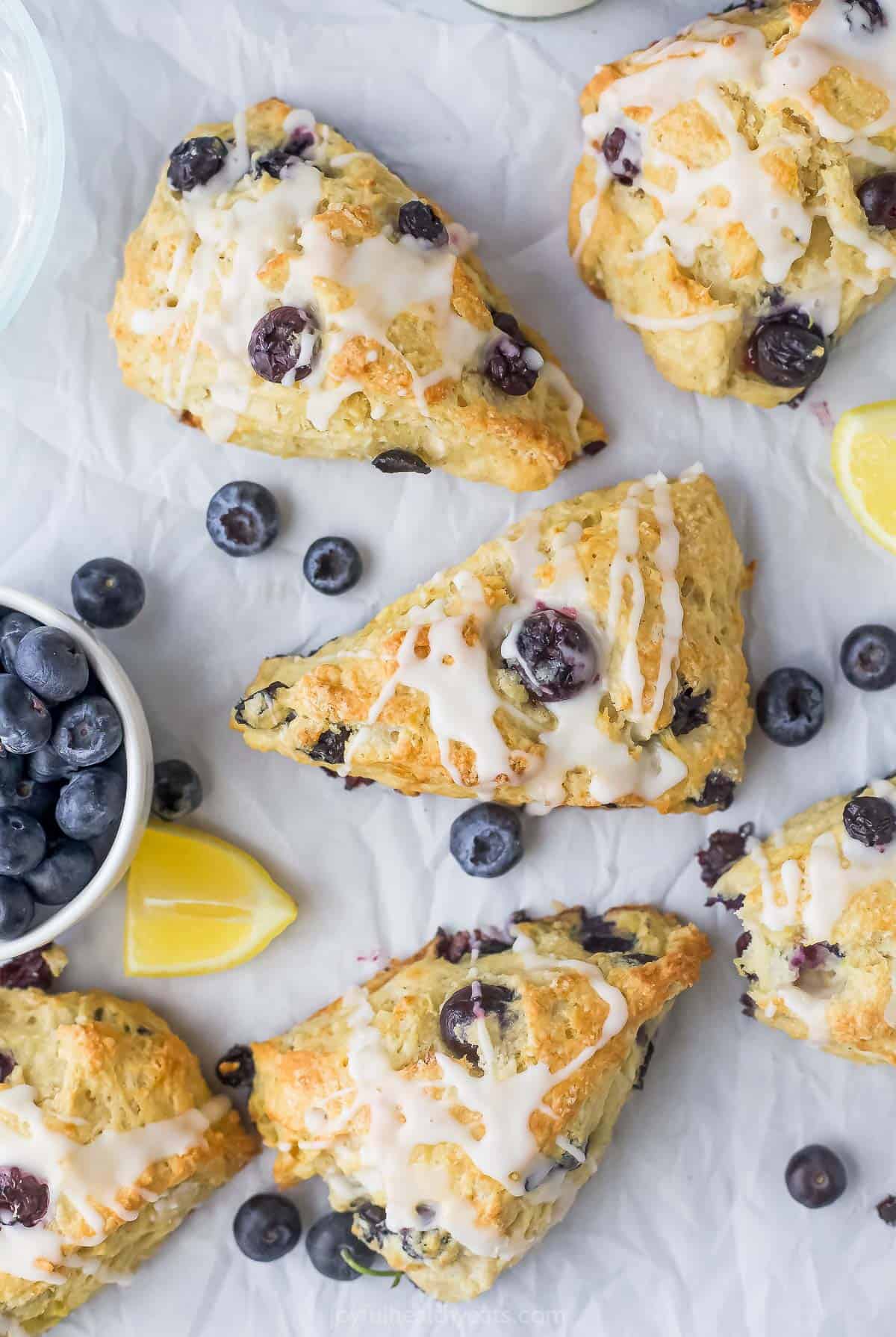 This easy lemon blueberry scones recipe with homemade sweet lemon glaze is a freezer-friendly breakfast option that tastes just like dessert. Lemon blueberry scones with lemon glaze.