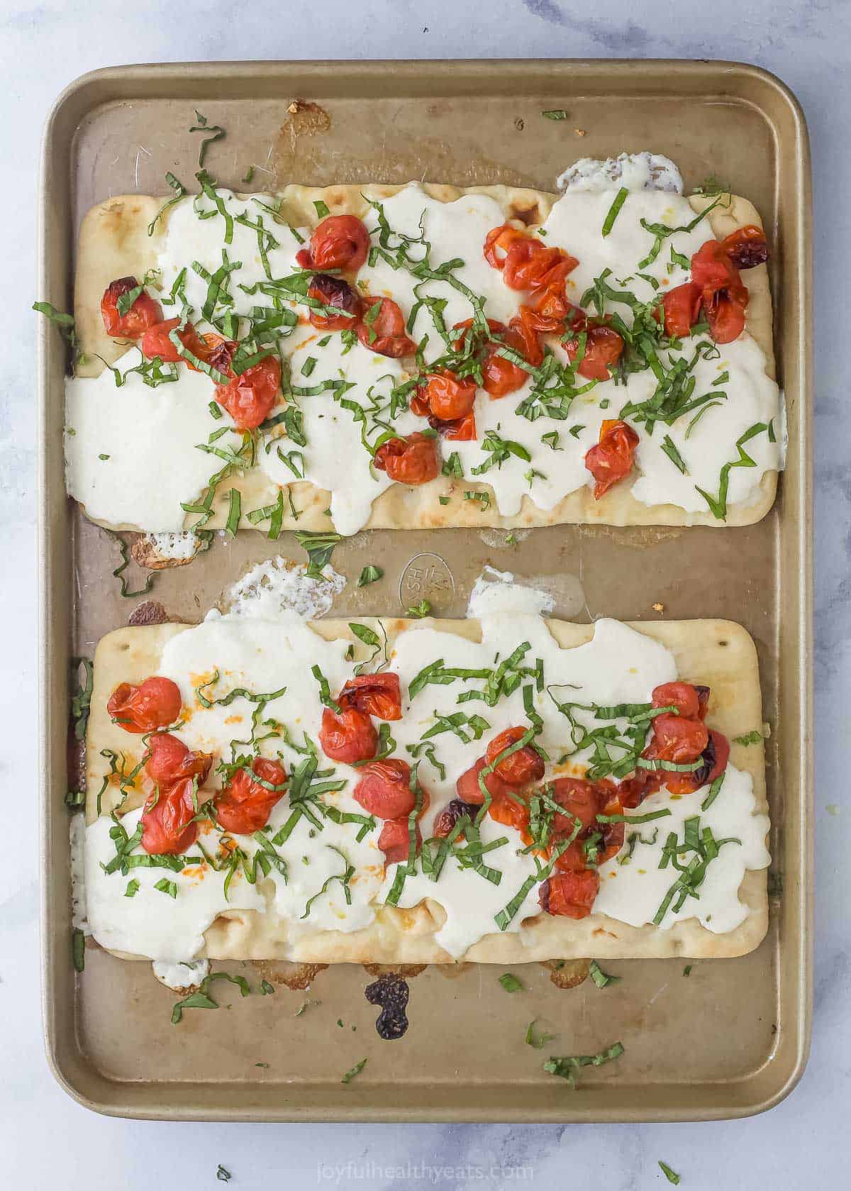 Baked flatbread pizzas with toppings.