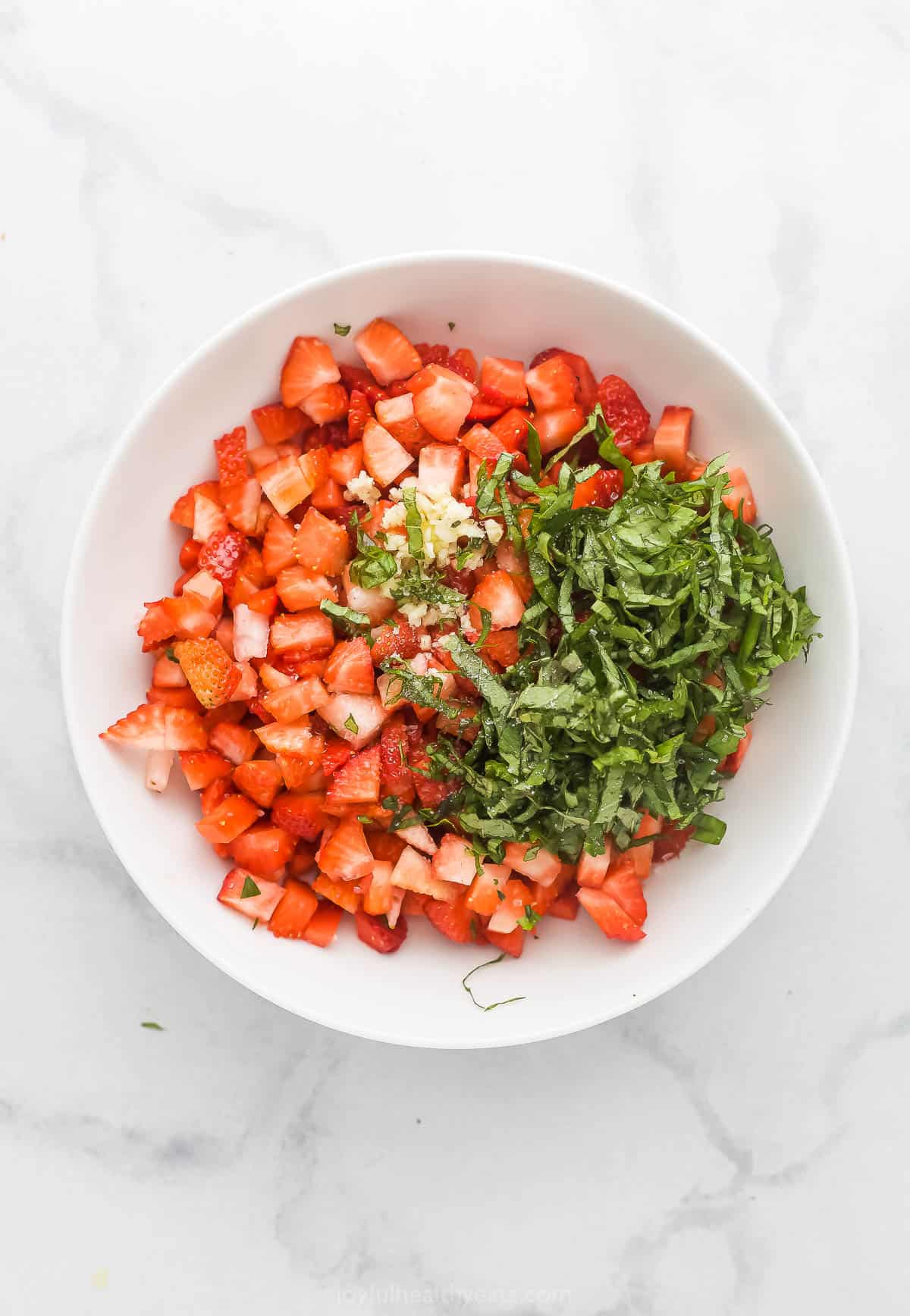 Mixing the fruity topping ingredients in a bowl.