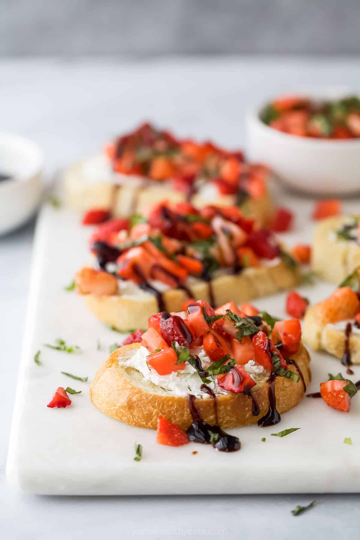Strawberry bruschettas on toasty bread with balsamic reduction. 