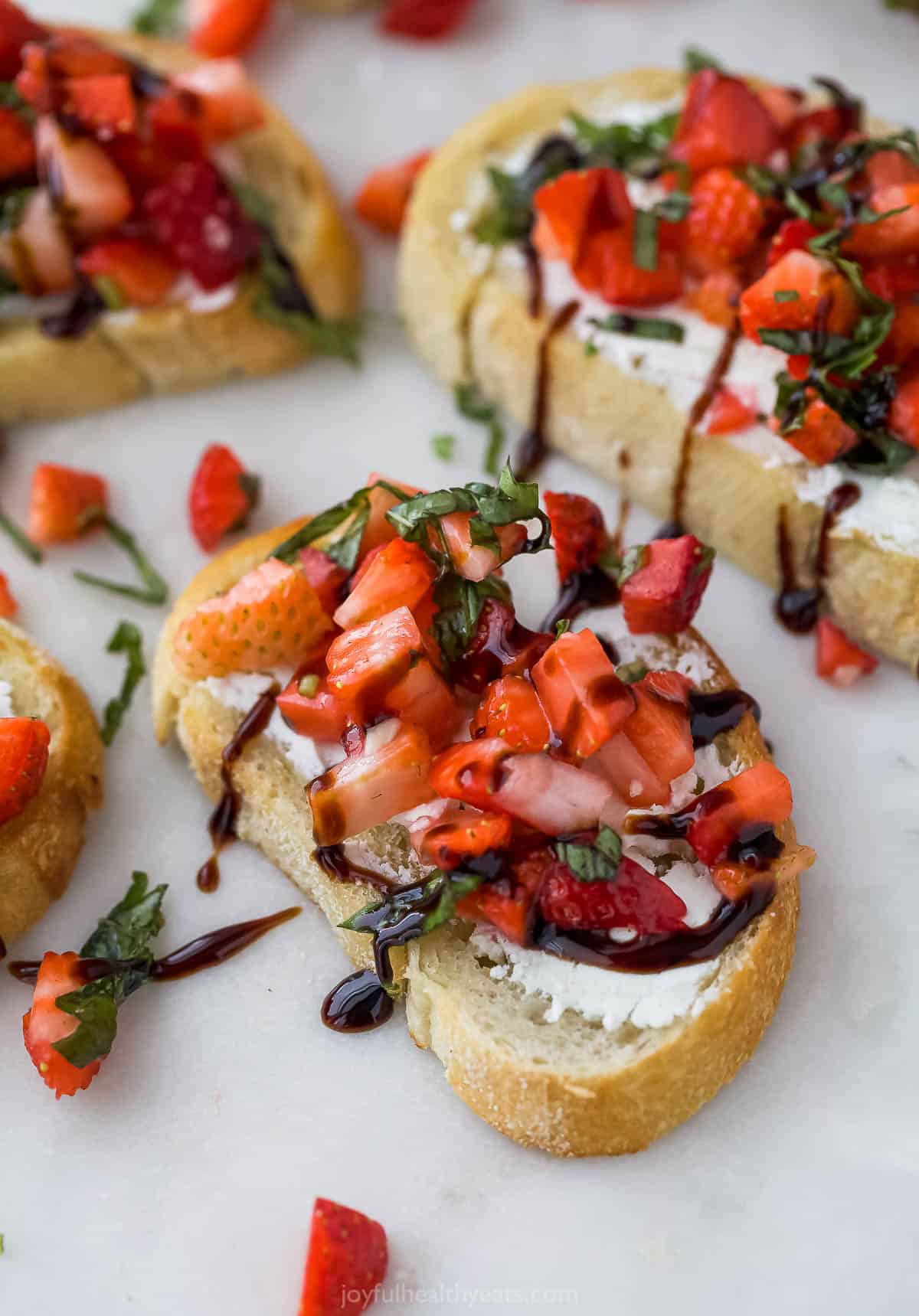 This refreshing strawberry bruschetta recipe with goat cheese spread and tangy balsamic reduction is an easy summer appetizer. Strawberry bruschetta with a drizzle of tangy balsamic reduction on top.
