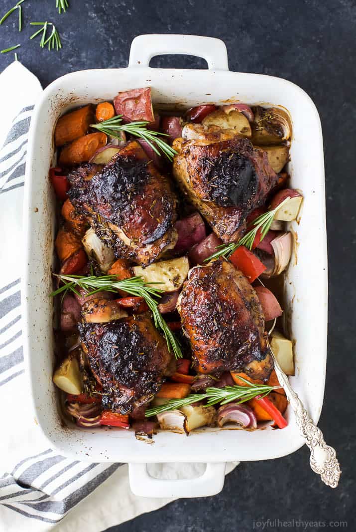 This crispy-skinned baked chicken with vegetables recipe is packed with spicy mustard, fresh rosemary, and garlic for the perfect bite. Baked chicken and vegetables with fresh rosemary in the baking dish.