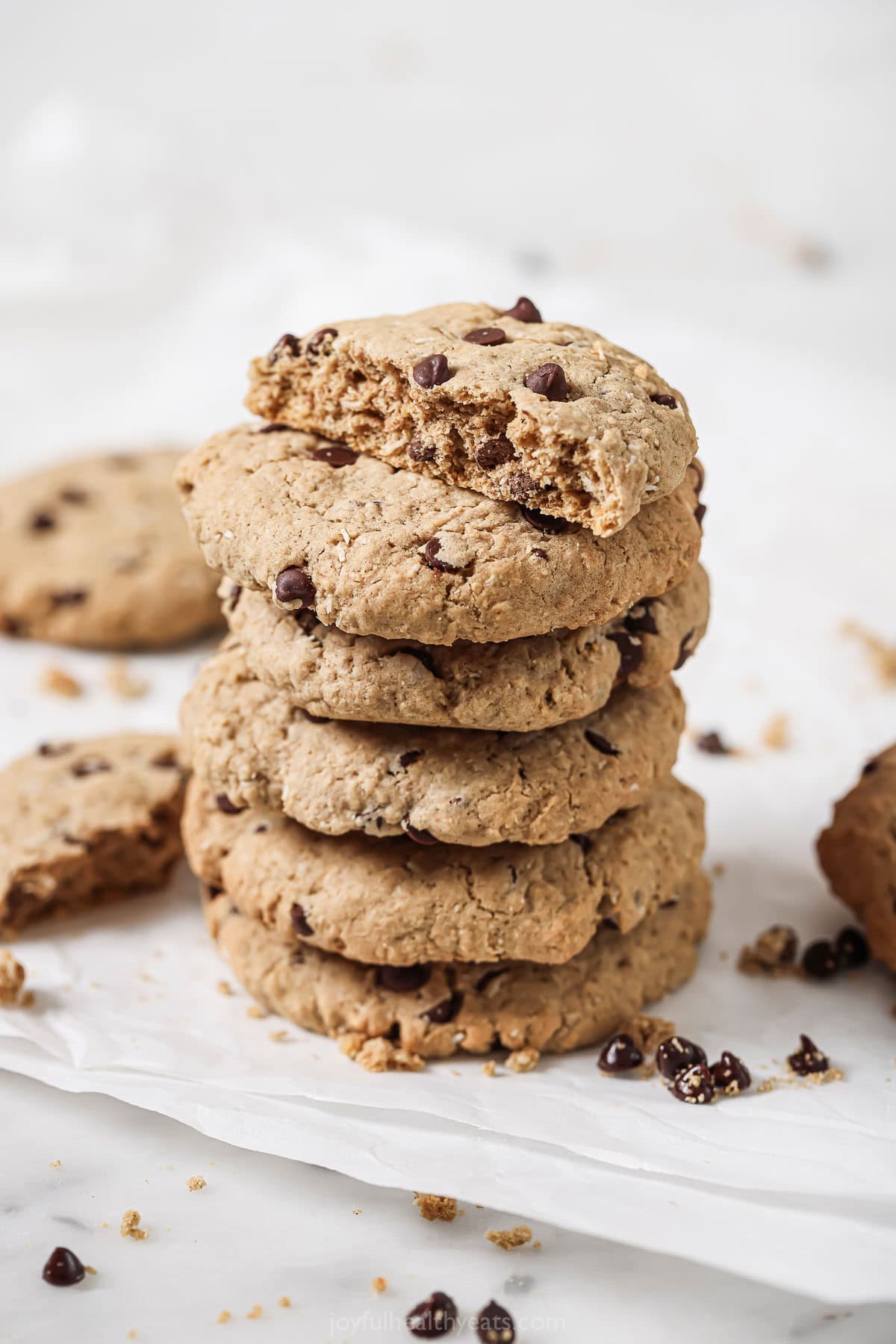 These freshly-baked coconut chocolate chip oatmeal cookies with earthy cinnamon will be your new favorite cookie recipe. A stack of freshly-baked coconut chocolate chip oatmeal cookies.
