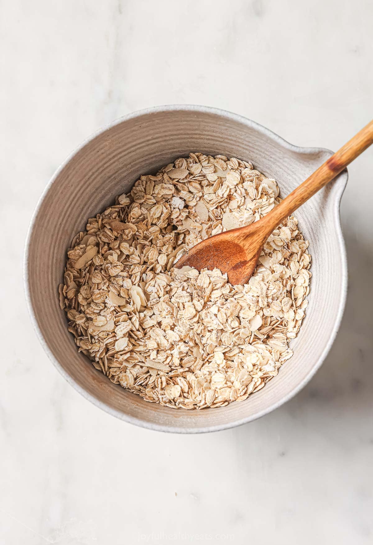 Dry ingredients for granola in mixing bowl