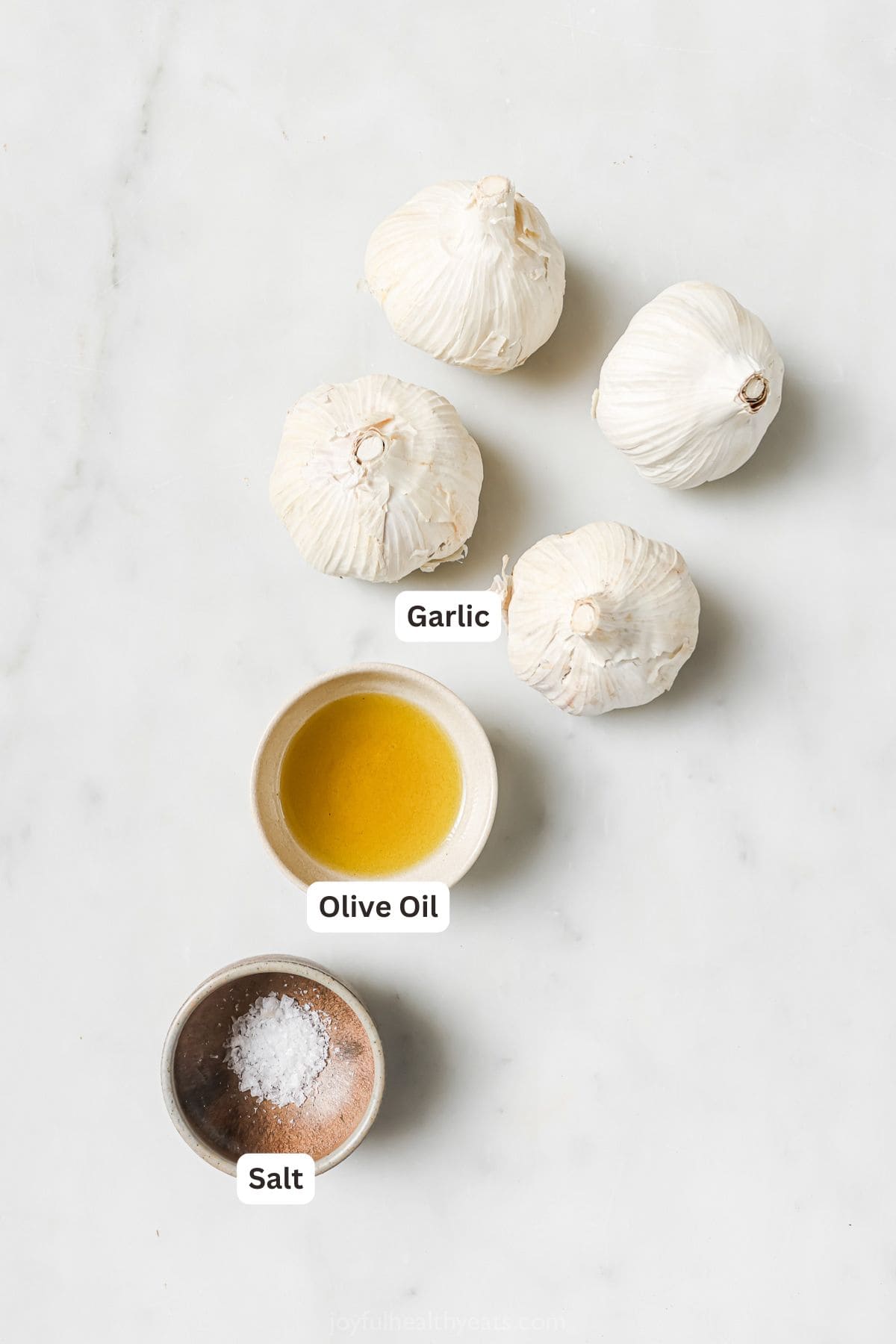 Overhead view of ingredients for roasted garlic with labels