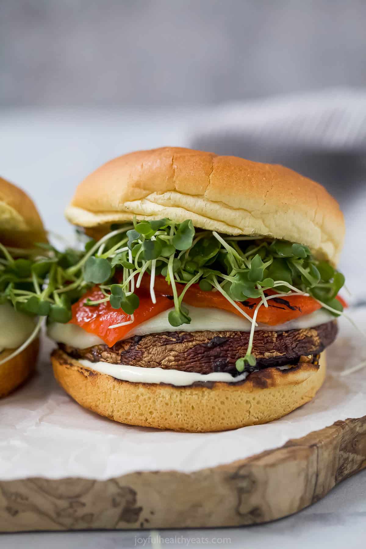 With melty provolone, roasted red pepper, and creamy truffle aioli, this just might be the best portobello mushroom sandwich EVER! Grilled portobello mushroom sandwich on brioche bun