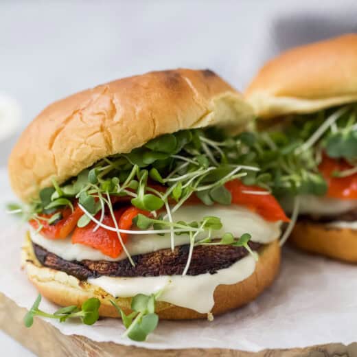 Grilled portobello mushroom sandwiches on wooden board