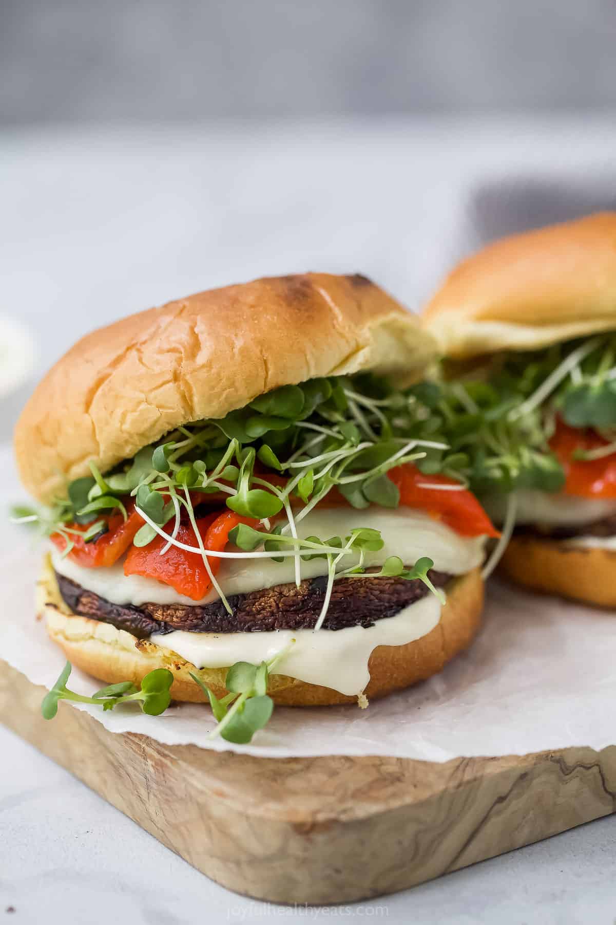 Grilled portobello mushroom sandwiches on wooden board