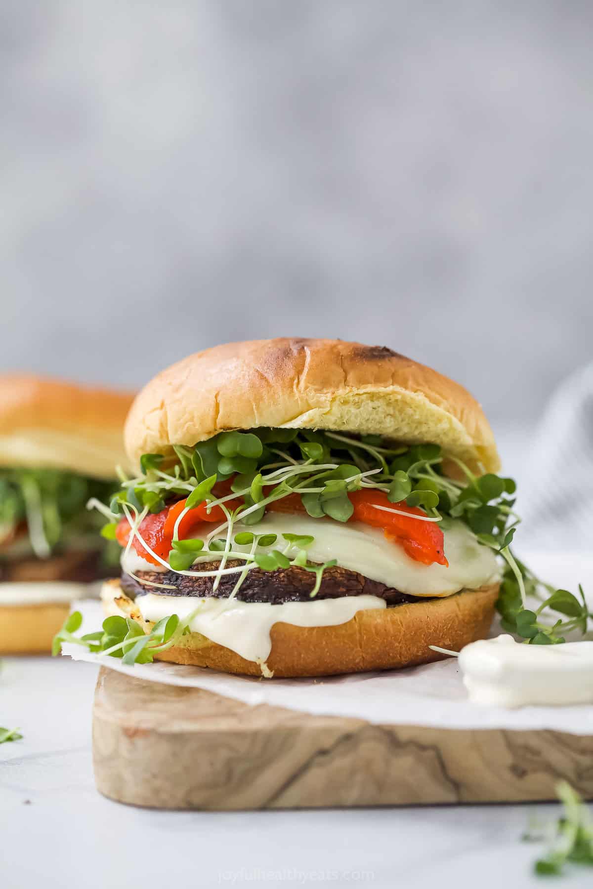 Grilled portobello mushroom sandwich on wooden board