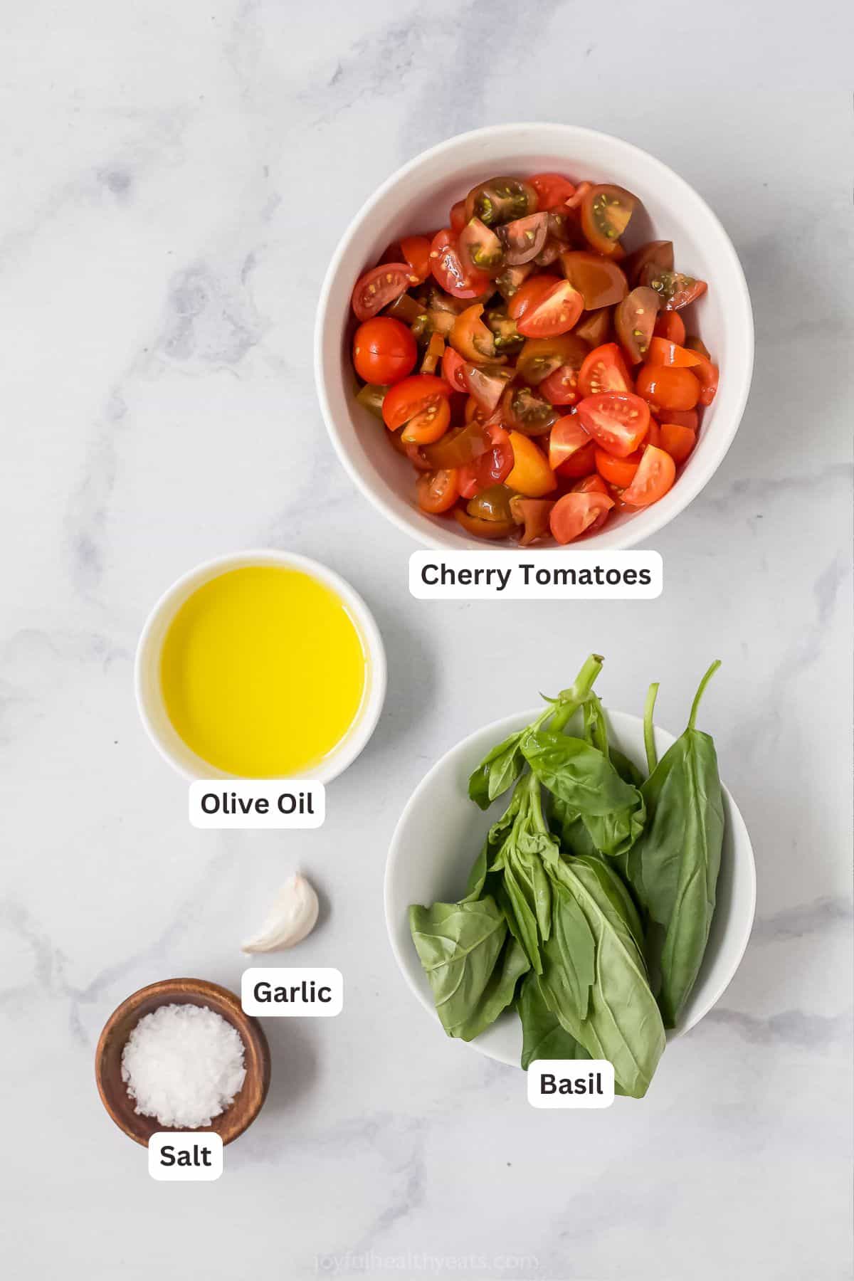 Overhead view of ingredients for tomato bruschetta with labels