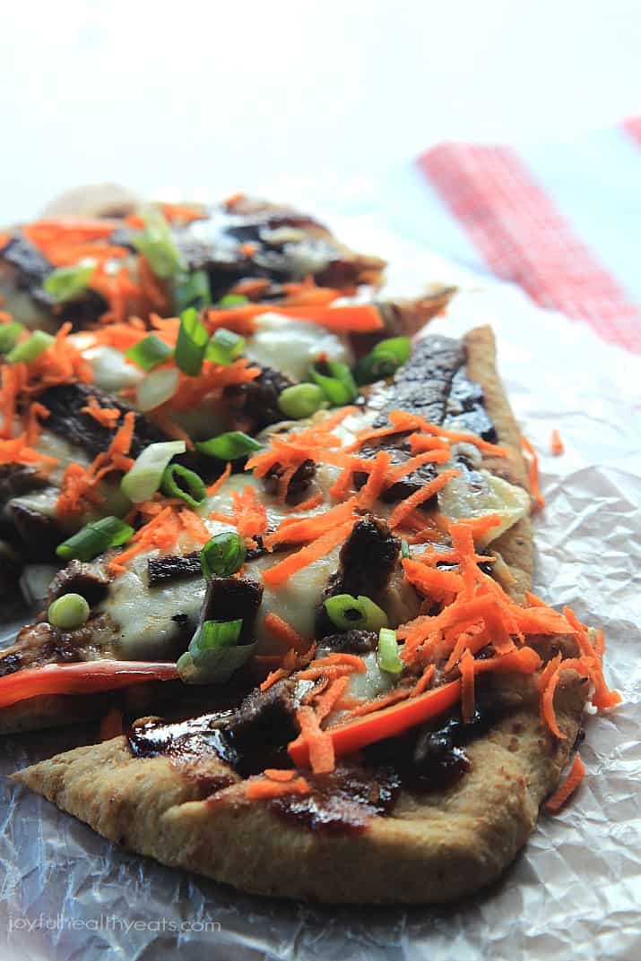 Grilled Asian Short Rib Pizza with Blackberry Hoisin Sauce A Grilled Pizza Topped with Veggies on a Piece of Crinkly Wax Paper