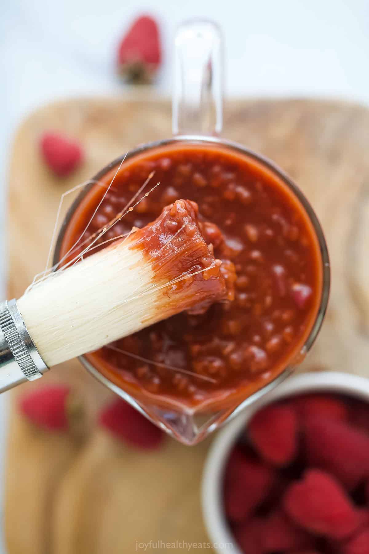 Close-up of a brush with fruity BBQ sauce. 