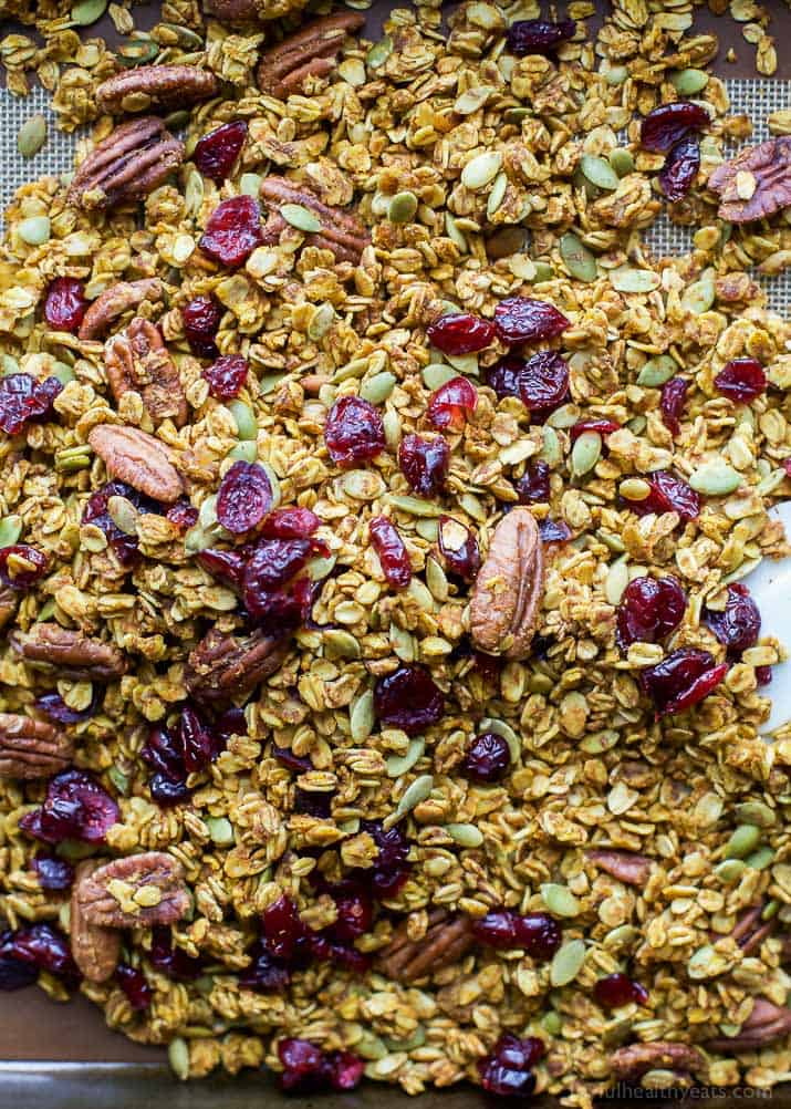 An easy healthy and Homemade Pumpkin Spice Granola Recipe you'll want to indulge on year round! All your favorite fall flavors in one granola recipe - pumpkin, allspice, nutmeg, cloves, cinnamon ... its fall in a bite! Only 190 calories a serving!