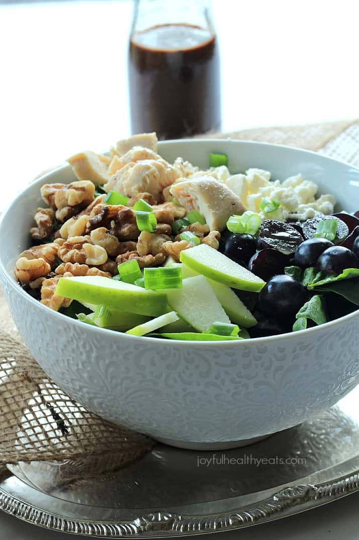 Chicken Feta Walnut Grape Chopped Salad with Balsamic Vinaigrette A Bowl of Chicken Feta Walnut Grape Salad Beside a Bottle of Honey Balsamic Vinaigrette