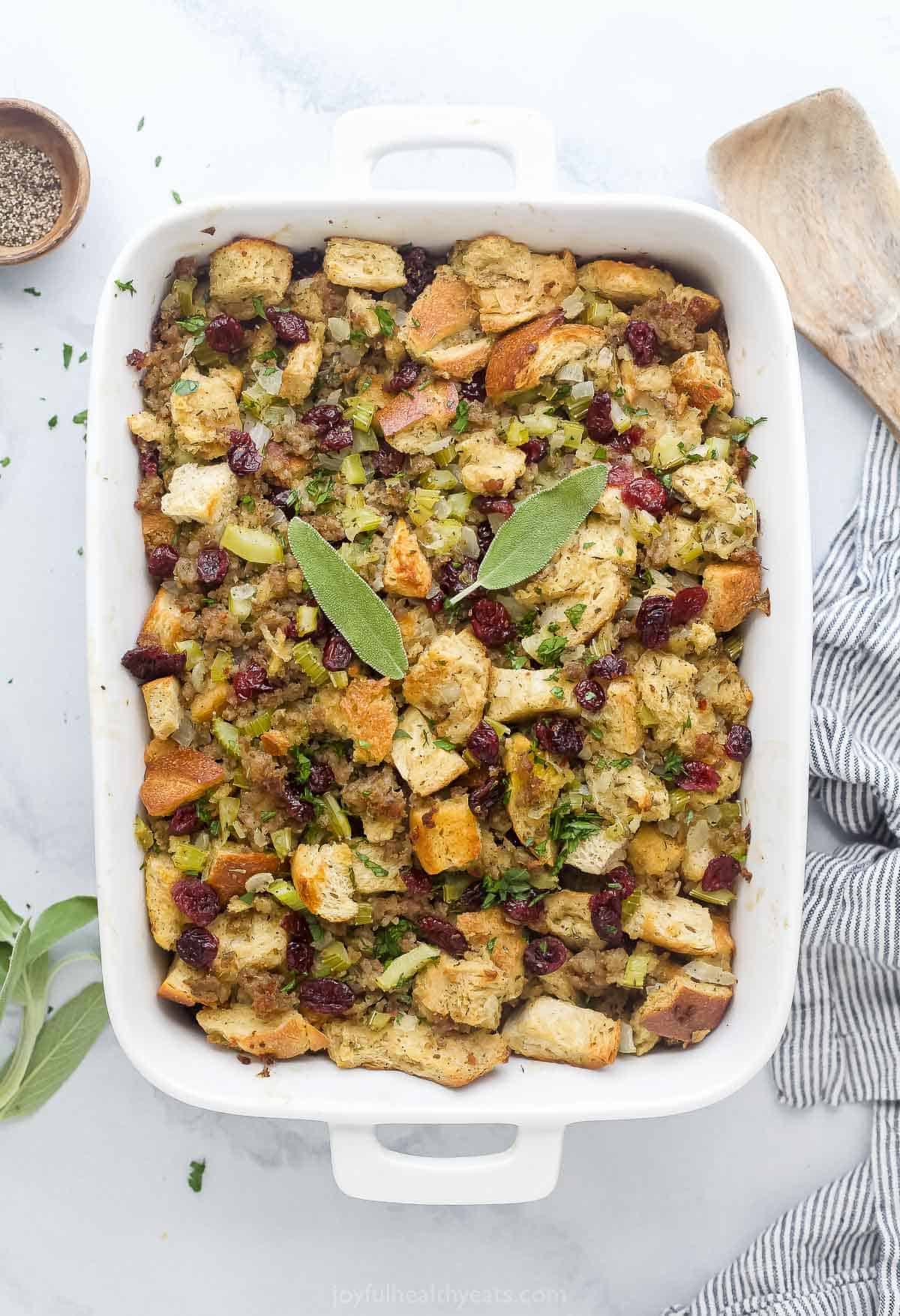 This sweet and savory cranberry sausage stuffing recipe is a hearty side dish packed with toasty bread and aromatic herbs everyone will love. Cranberry sausage stuffing in the baking pan.