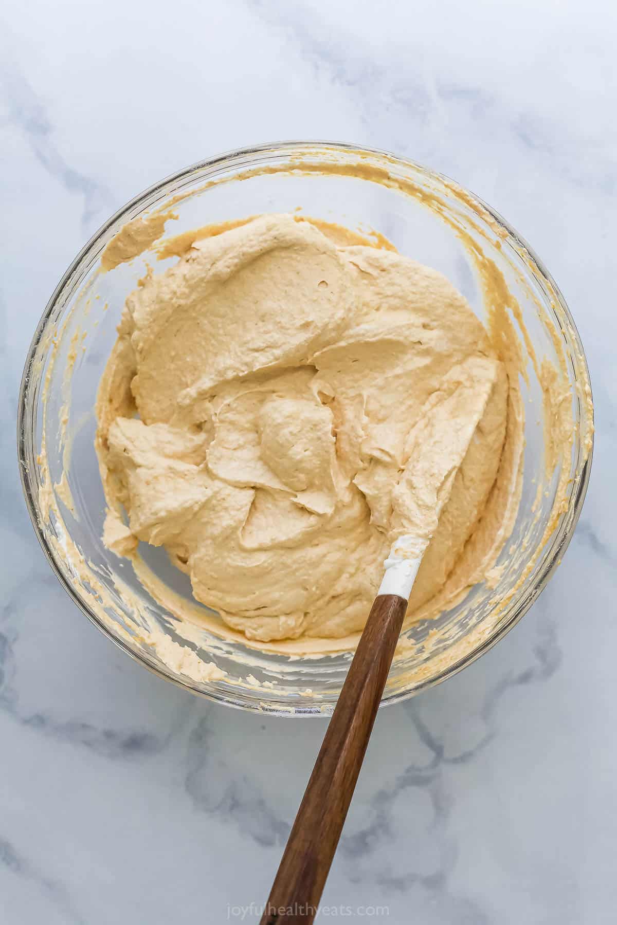 Folding the Cool Whip into the pumpkin mixture.