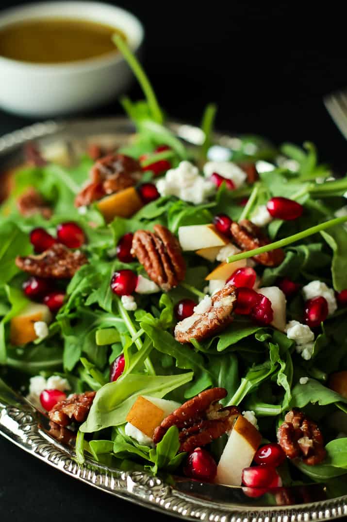 Pomegranate Goat Cheese Candied Pecan Arugula Salad. The perfect salad to change up your holiday menu, easy to make and absolutely delicious! | purewellnessjourneyclub.com