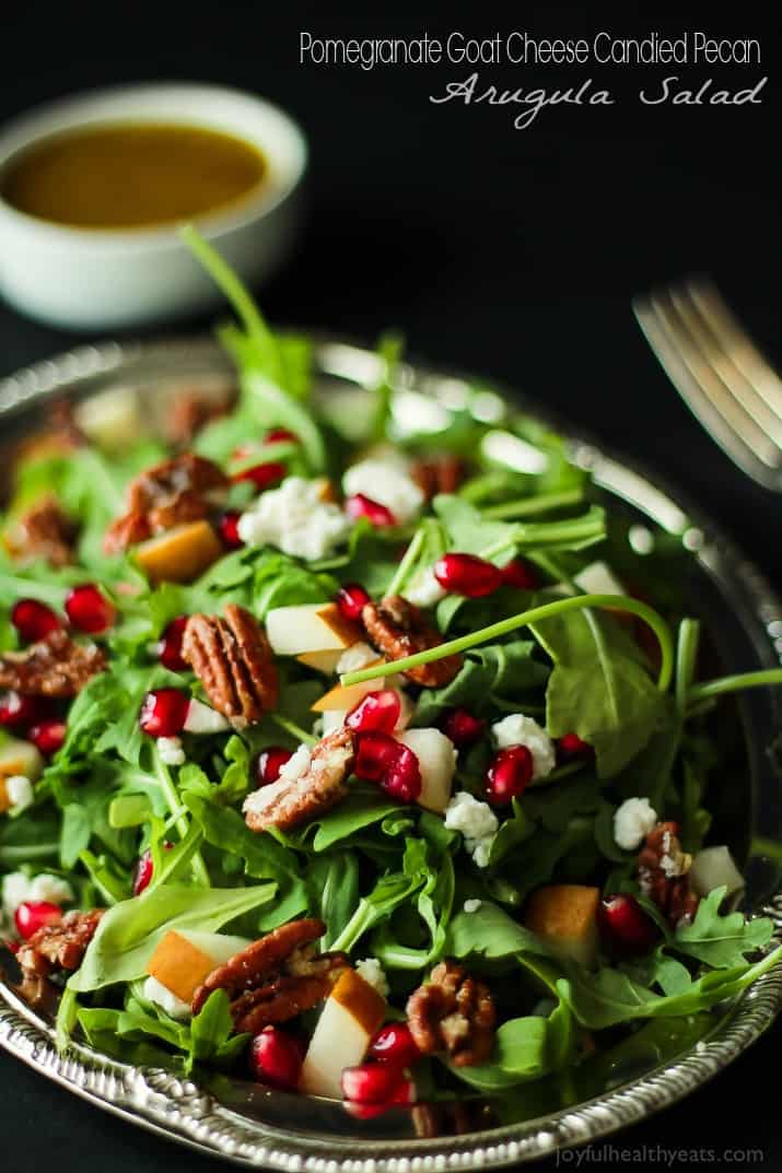 Pomegranate Goat Cheese Candied Pecan Arugula Salad. The perfect salad to change up your holiday menu, easy to make and absolutely delicious! | purewellnessjourneyclub.com