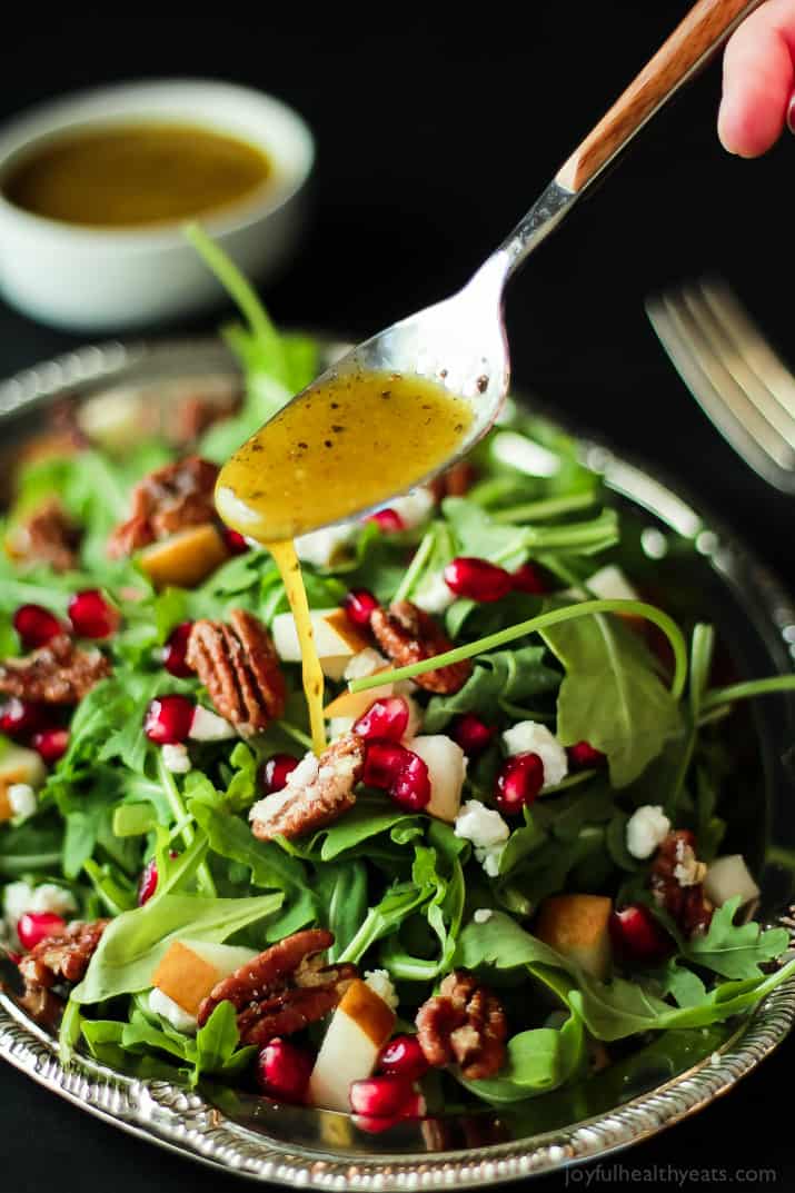 Pomegranate Goat Cheese Candied Pecan Arugula Salad. The perfect salad to change up your holiday menu, easy to make and absolutely delicious! | purewellnessjourneyclub.com