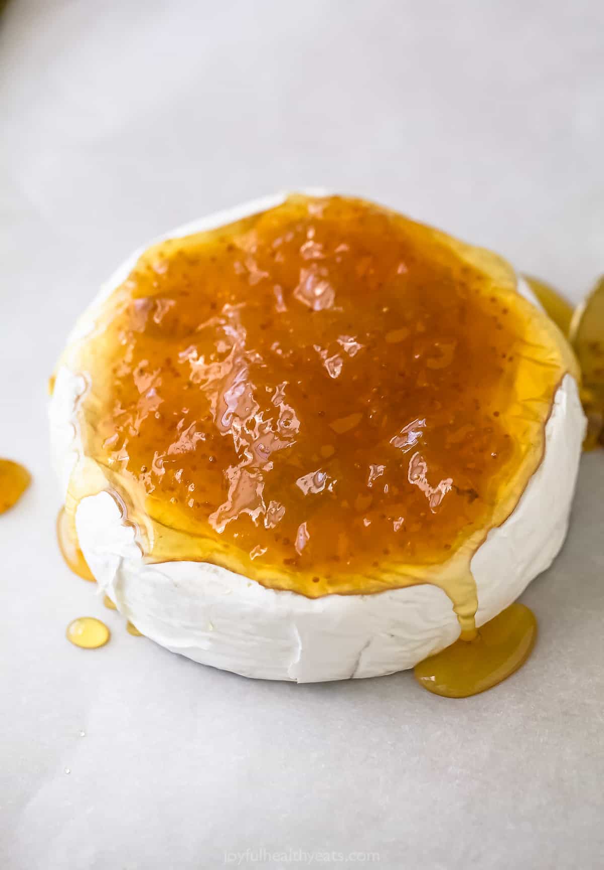 Spreading the jam on top.