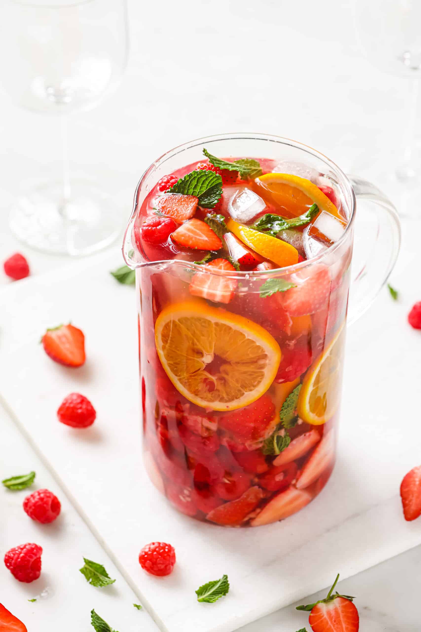 Packed with sweet summer fruits, this refreshing strawberry sangria is loaded with brandy and crisp rosé wine for the perfect cocktail. Pitcher of strawberry sangria with ice.