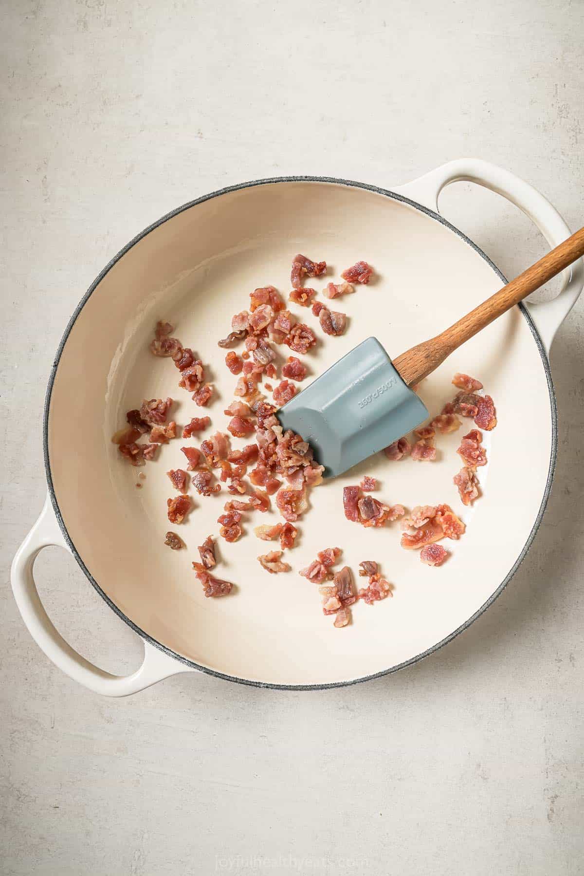 Overhead view of bacon cooking in skillet