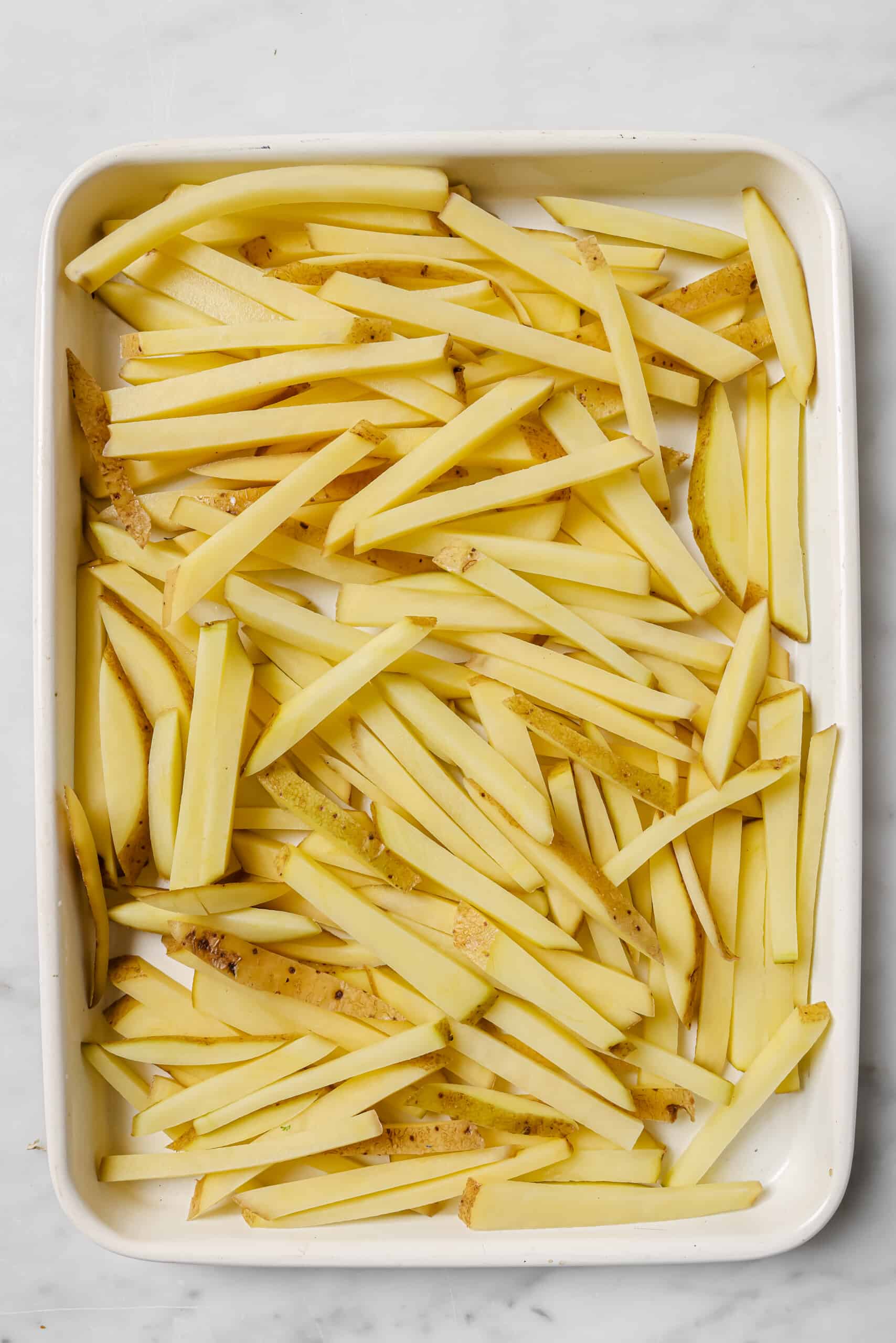 Spreading the soaked potatoes to dry them.