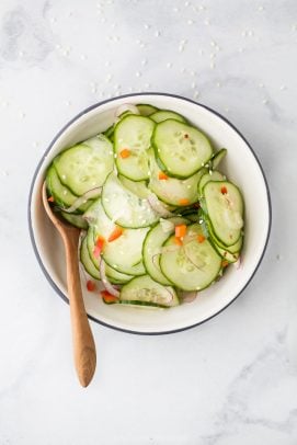 overhead photo of 10 Minute Easy Asian Cucumber Salad Recipe (Dairy Free) in a bowl with a spoon