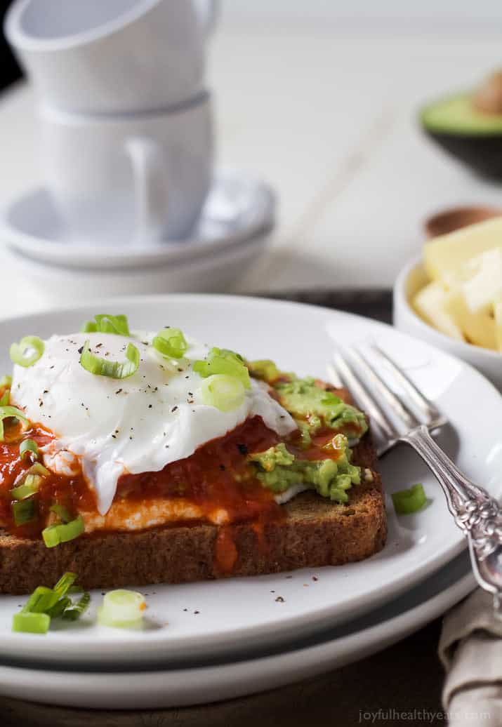 Toast with mashed avocado, ricotta, harissa, and a poached egg. 