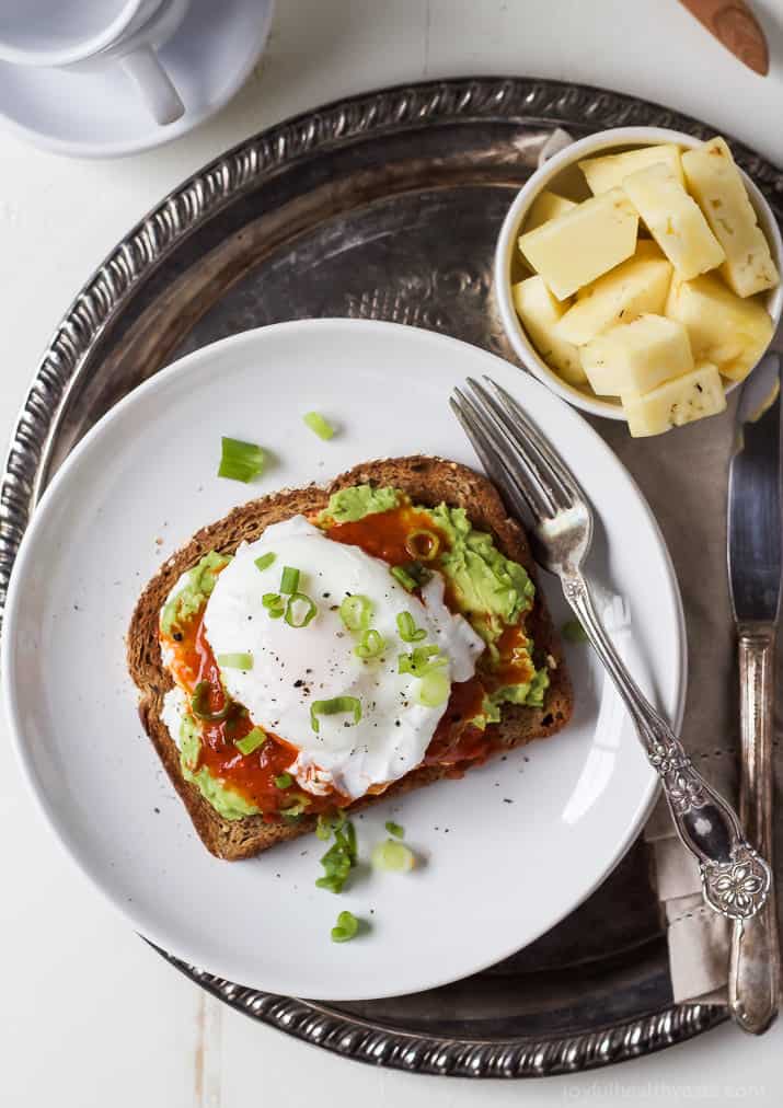 Overhead photo of avocado toast with poached egg on a serving plate. 