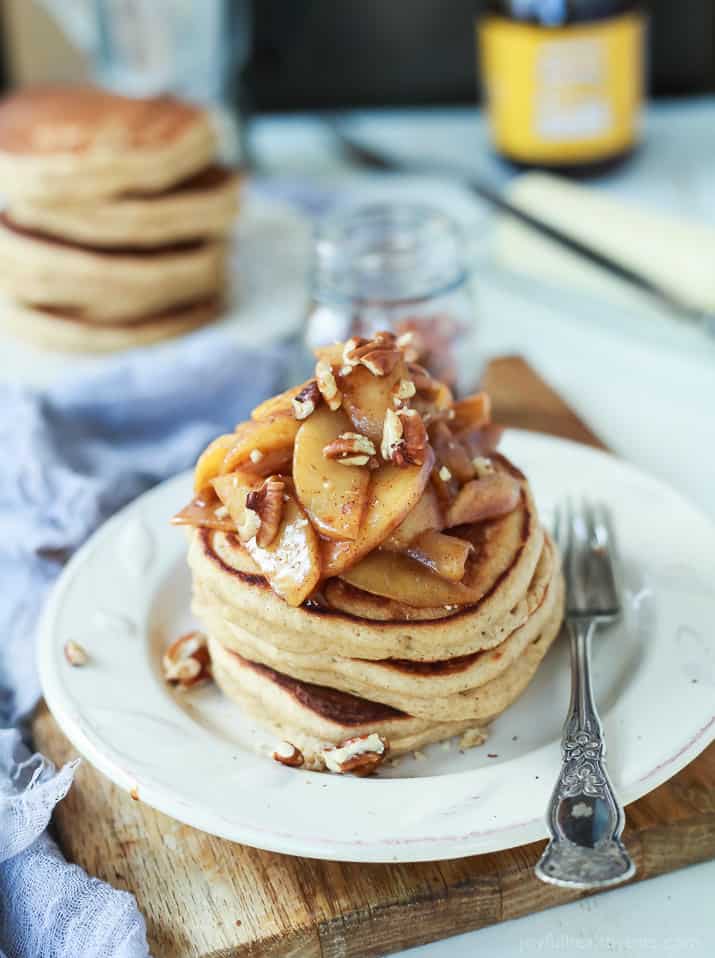 A stack of whole wheat pancakes topped with apple compote.