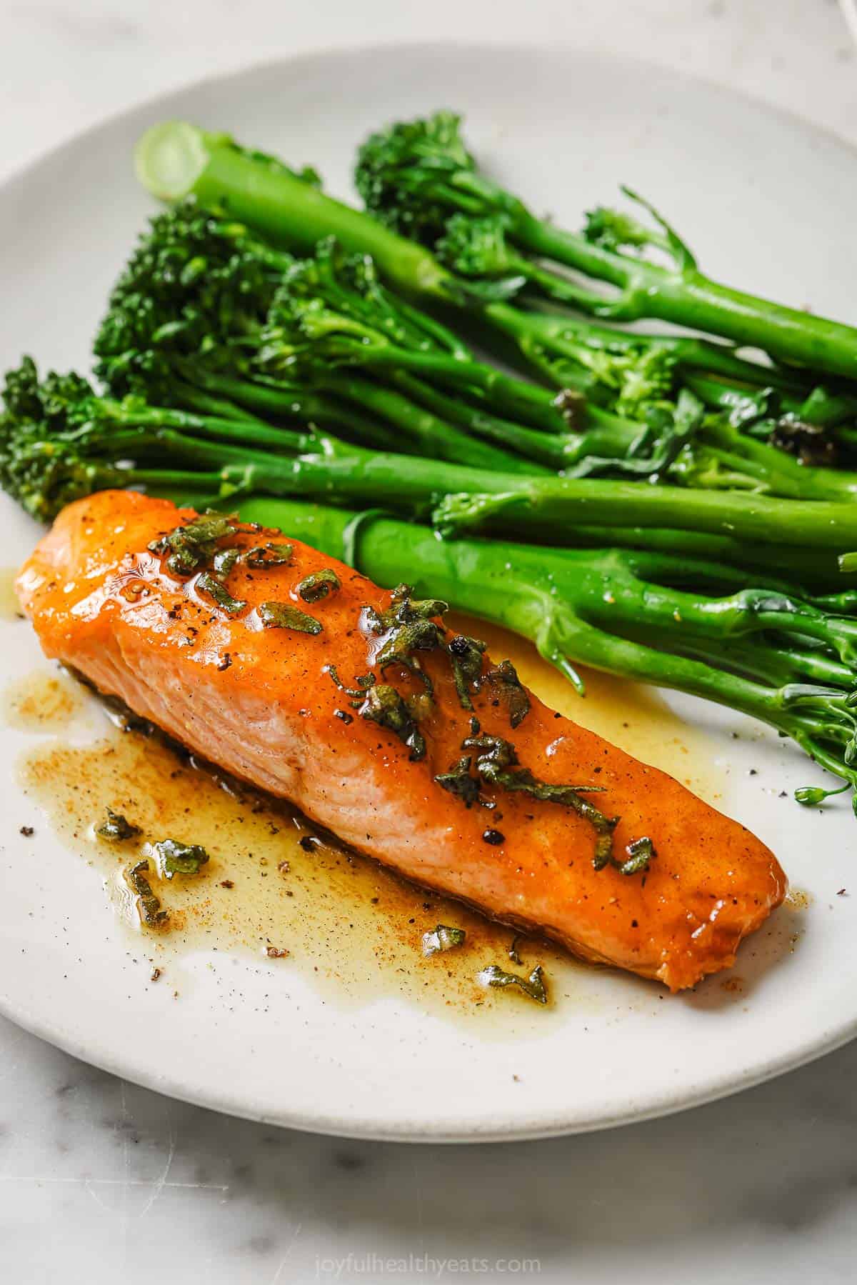 This quick pan seared salmon recipe with brown butter sage sauce with hints of honey is perfect for weeknights and special occasions. Pan seared salmon recipe with brown butter sauce and broccolini on the side.