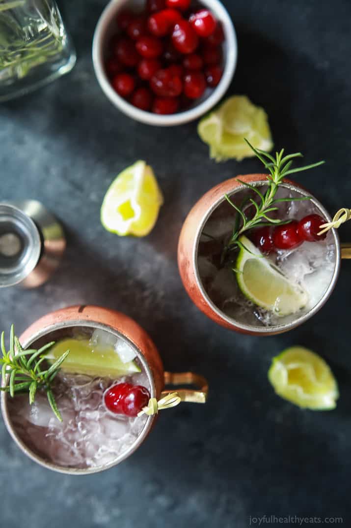 Top view of two cranberry Moscow mule mugs with rosemary-infused vodka.