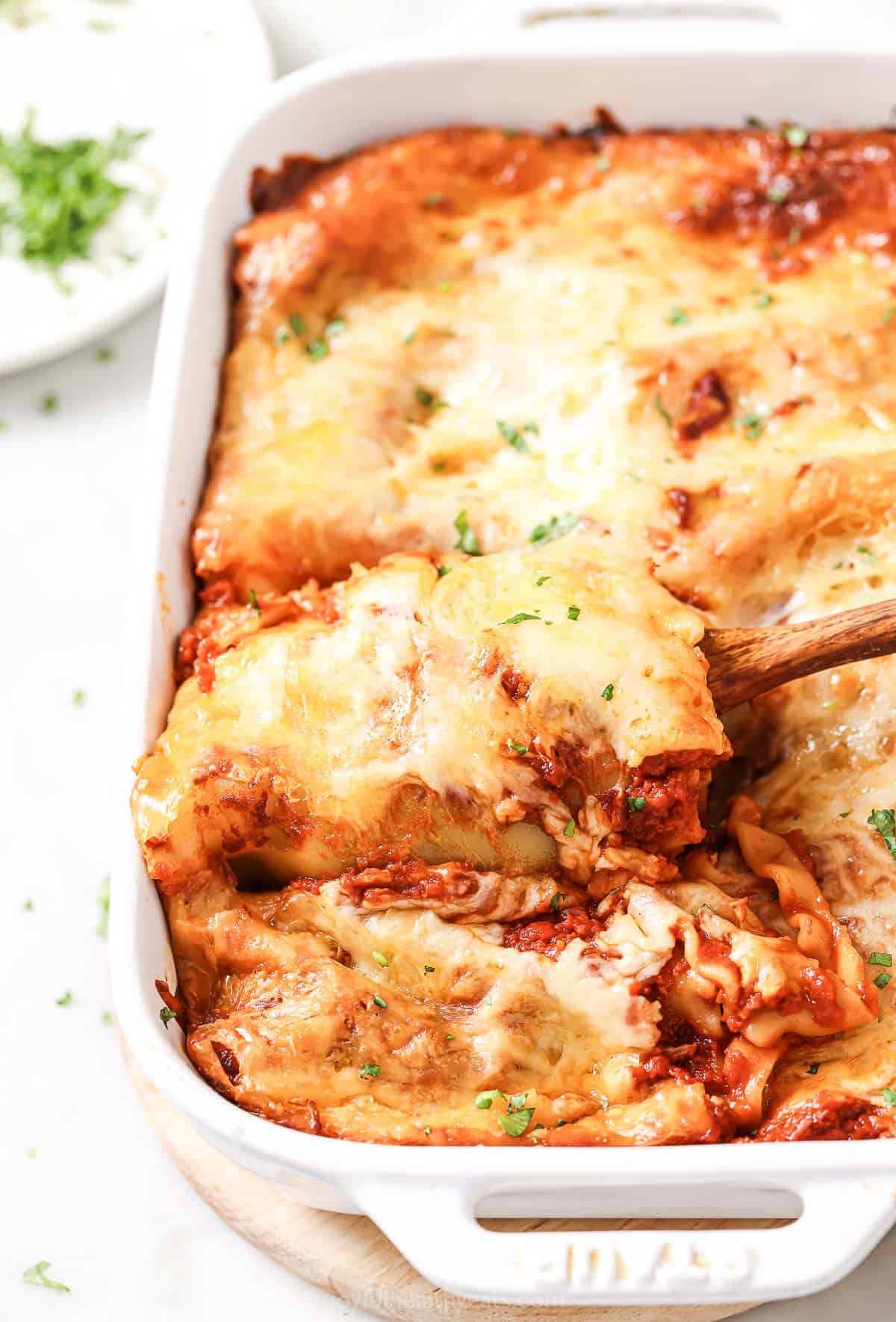 This cheesy lasagna rolls recipe with tomatoey marinara, cottage cheese, and garlicky spinach is an easy baked dinner you'll love. Cheesy lasagna rolls with marinara sauce in the baking dish.