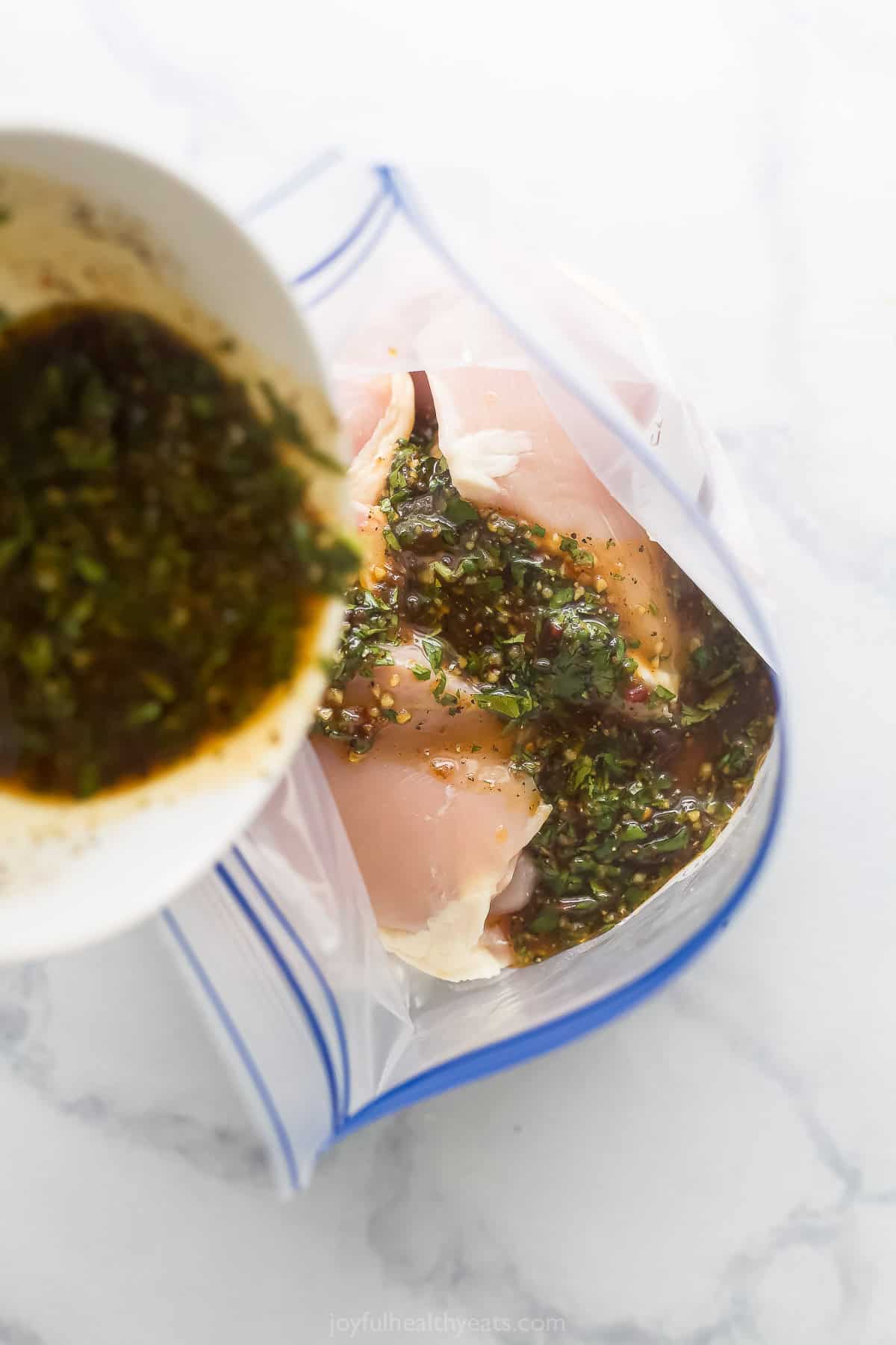 Pouring the marinade into the chicken. 