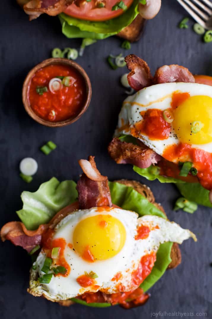 Open Faced BLT Sandwich with Harissa A Bird's-Eye View of Open Faced BLT Breakfast Sandwiches on a Black Surface