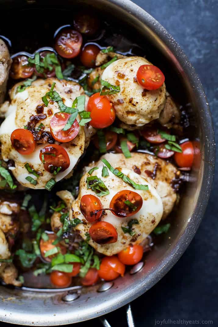 This easy Balsamic Glazed Caprese Chicken recipe is made in just one pan. It has tangy tomatoes, mozzarella cheese, and fresh herbs. Close-up Image of Balsamic Glazed Caprese Chicken which is chicken with cheese, tomatoes, and fresh basil