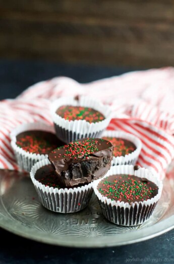 A few Thin Mint Oreo Bites wrapped in liners and topped with red and green Christmas sprinkles | joyfulhealthyeats.com