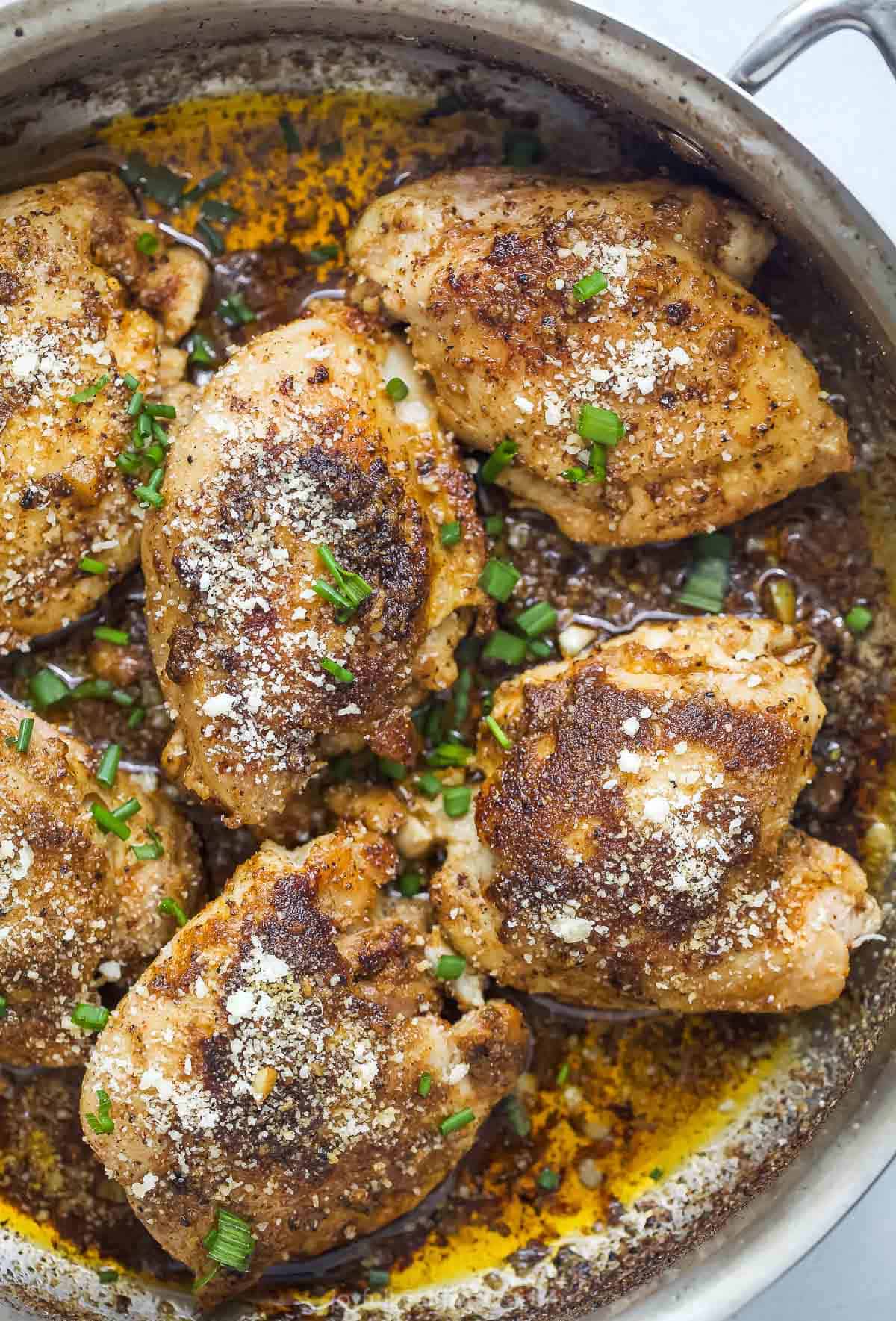 These one-pan parmesan chicken thighs with a garlicky sauce are a quick and simple weeknight dinner you'll love. Parmesan chicken thighs with garlic butter sauce.
