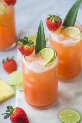 Overhead view of glasses of pineapple strawberry agua fresca